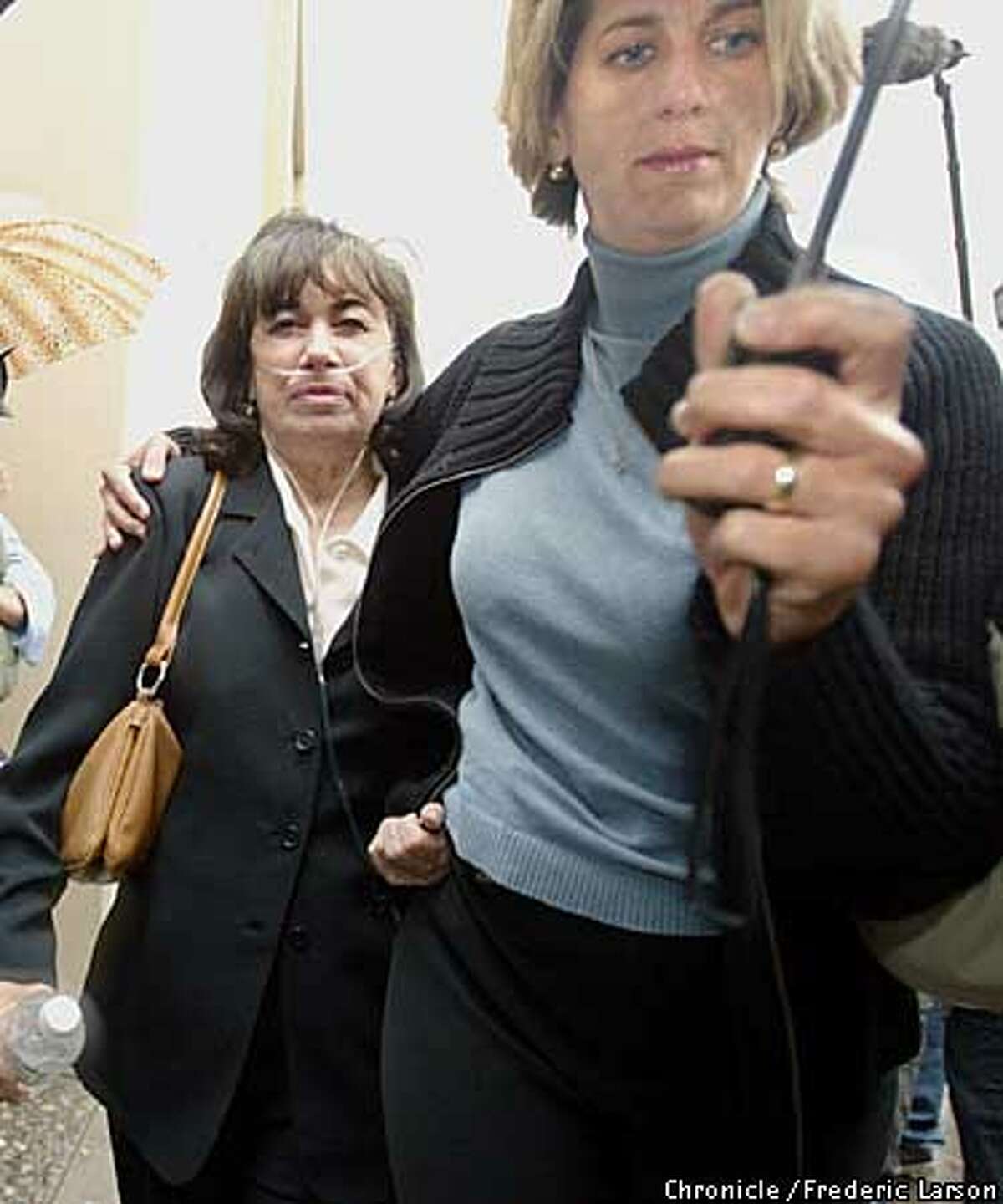 BODIES2-C-21APR03-MT-FRL: Jackie Peterson the mother of accused murderer Scott Peterson was escorted by her daughter-in-law Janey Peterson to the Stanislaus County Superior Court in Modesto for Scott's arraignment. Scott Peterson pleaded innocent Monday to killing his pregnant wife and unborn son, as prosecutors filed charges against him that could bring the death penalty. Chronicle photo by Frederic Larson