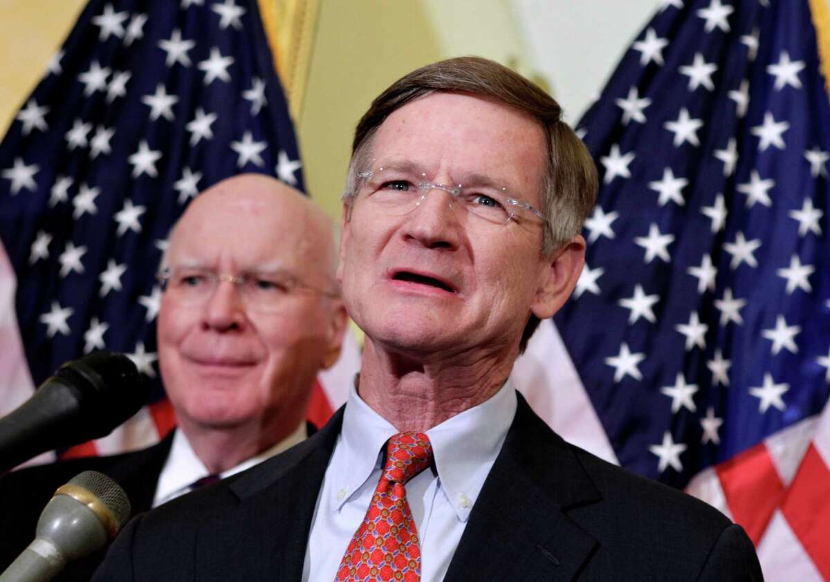 House Judiciary Committee Chairman Rep. Lamar Smith, R-Texas, right, accompanied by Senate Judiciary Committee Sen. Patrick Leahy, D-Vt., speaks during a news conference on Capitol in Washington, Monday, April 4, 2011, to discuss their efforts to thwart the harm done to the economy by online vendors dealing in counterfeit goods or copyright infringement. (AP Photo/J. Scott Applewhite)