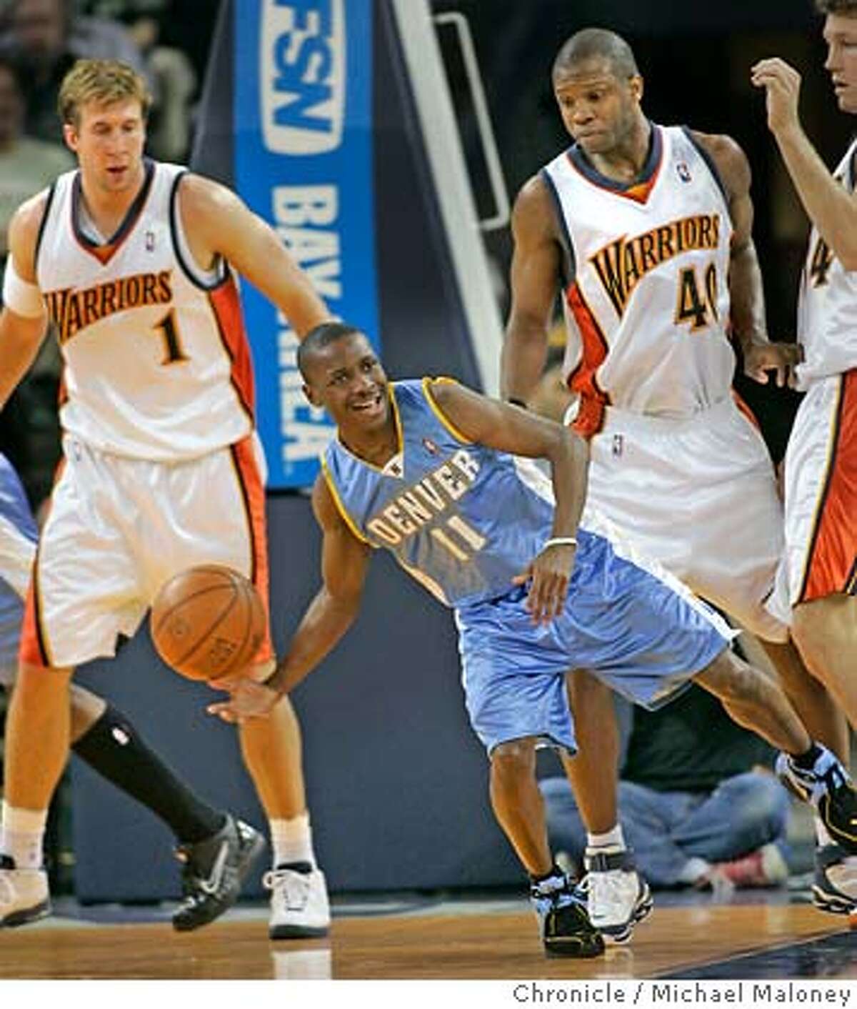 Five foot five Earl Boykins of Denver looks for someone to pass to as Warriors #1 Troy Murphy, #40 Calbert Cheaney and 34 Mike Dunleavy look on in the 2nd period. Golden State Warriors vs Denver Nuggets at The Arena in Oakland. Event in Oakland, CA Photo by Michael Maloney / The Chronicle