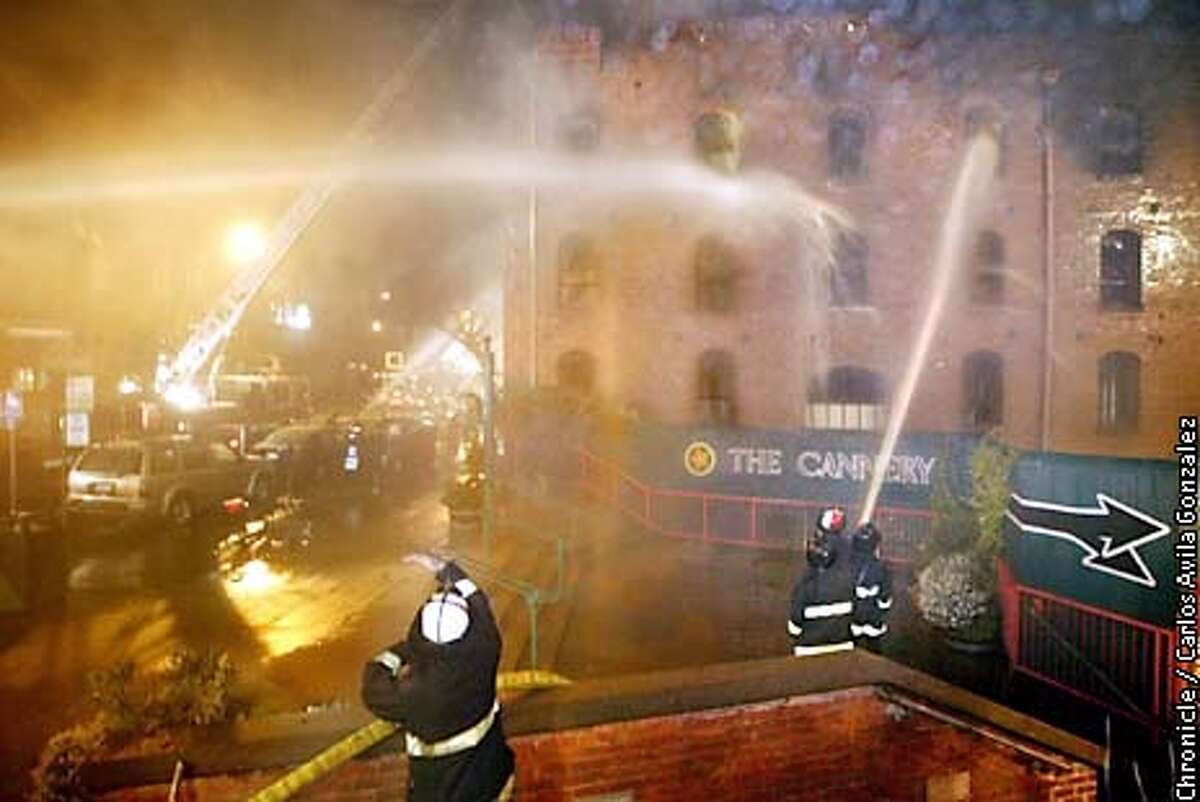 San Francisco firefighters battle a blaze at The Cannery, a historical landmark on San Francisco's Fisherman's Wharf, Sunday March 17, 2002. The fourth floor and roof of the building were completely destroyed, although the brick facade still stands, Capt. Pete Howes said. The building was built around 1907 and was undergoing renovations. (AP Photo/San Francisco Chronicle, Carlos Avila Gonzalez)