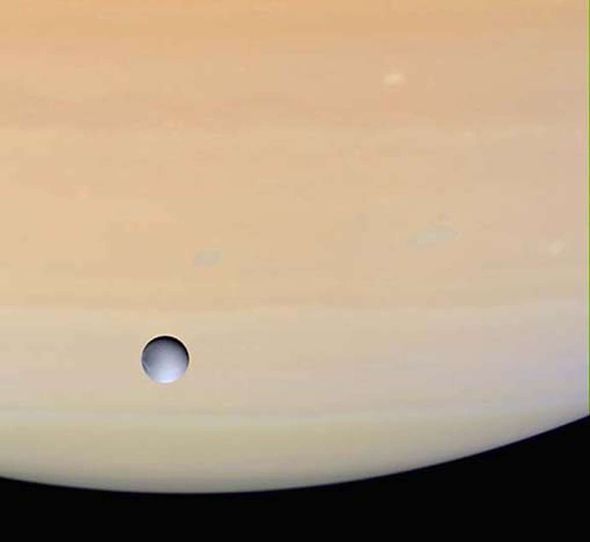 In this image released by NASA on Thursday, Dec. 16, 2004, Saturn's moon Dione is shown against the globe of Saturn as Cassini approached the icy moon for its close rendezvous on Dec. 14, 2004. The images used to create this view were obtained with the Cassini spacecraft wide-angle camera at a distance of approximately 603,000 kilometers (375,000 miles) from Dione. (AP Photo/NASA/JPL/Space Science Institute) Ran on: 12-24-2004 Dione, another moon of Saturn, is shown with the solar system's sixth planet in the background. Ran on: 12-24-2004 Dione, another moon of Saturn, is shown with the solar system's sixth planet in the background. Ran on: 12-24-2004 Dione, another moon of Saturn, is shown with the solar system's sixth planet in the background. PHOTO PROVIDED BY NASA/JPL/SPACE SCIENCE INSTITUTE.