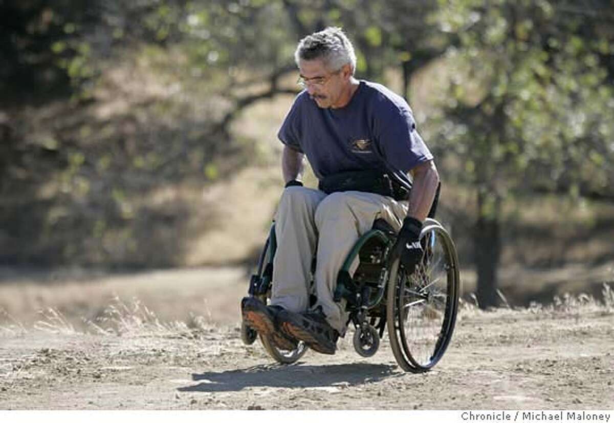 WHEELCHAIR_35_MJM.jpg Bob Coomber hikes at one of his favorite hikes - the trails of Morgan Territory Park near Livermore. Bob Coomber is wildland enthusiast. He spends most of his free time in the east bay parks or Sierra, exploring the wide open spaces. He is also a paraplegic, and his excursions are all conducted via an all-terrain wheelchair. Coomber is an activist for making more of the wilderness wheelchair accessible, but only, he says, in a "gentle" way. He feels many areas are inappropriate for improved trails, and he wants only minimal grading for those areas where they make sense. Folks in wheelchairs, he feels, have to be up to the challenge, conditioning themselves to handle the wilderness. Photo by Michael Maloney / San Francisco Chronicle Ran on: 10-18-2004 Bob Coomber crests a hill on one of his favorite hikes, a 6-mile loop in the Morgan Territory Regional Preserve east of Mount Diablo. MANDATORY CREDIT FOR PHOTOG AND SF CHRONICLE/ -MAGS OUT