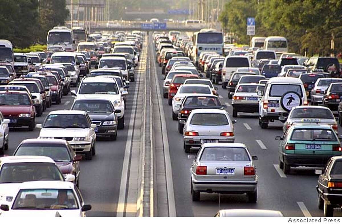 ** ADVANCE FOR SUNDAY, MAY 29 **FILE**Cars clog Beijing's Second Ring Road in the afternoon rush hour Thursday, June 10, 2004. Car sales in China are expected to total as many as 10 million vehicles annually by 2010. In Beijing alone, more than 1000 new cars hit the city's streets each day, resulting in major traffic problems and much higher energy use. (AP Photo/str) Ran on: 05-29-2005 About 8 percent of Canadas oil is produced by liquefying oil found in tar sands. Workers here overlook Suncors tar sands processing plant in Fort McMurray, Alberta. HFR 05-29-05. ADVANCE FOR SUNDAY, MAY 29