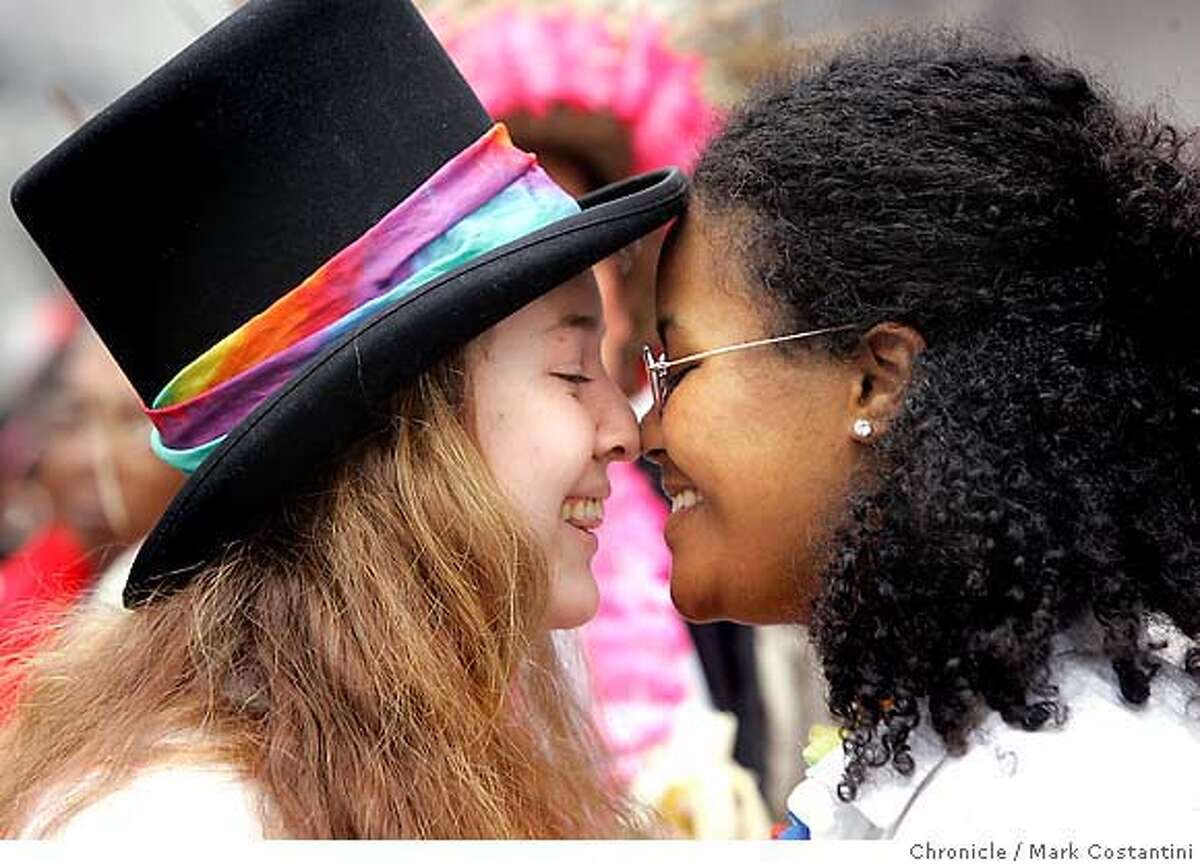 (L-R) Juliette Capra and Ashlyn Adamsof Berkeley share a moment at the parade. Spectators at the the Pride 2005 Gay pride parade. Photograph by Mark Costantini/S.F. Chronicle. Juliette Capra and Ashlyn Adams of Berkeley share a moment at the Gay Pride Parade on Sunday, June 26, 2005, in San Francisco. Chronicle photo by Mark Costantini