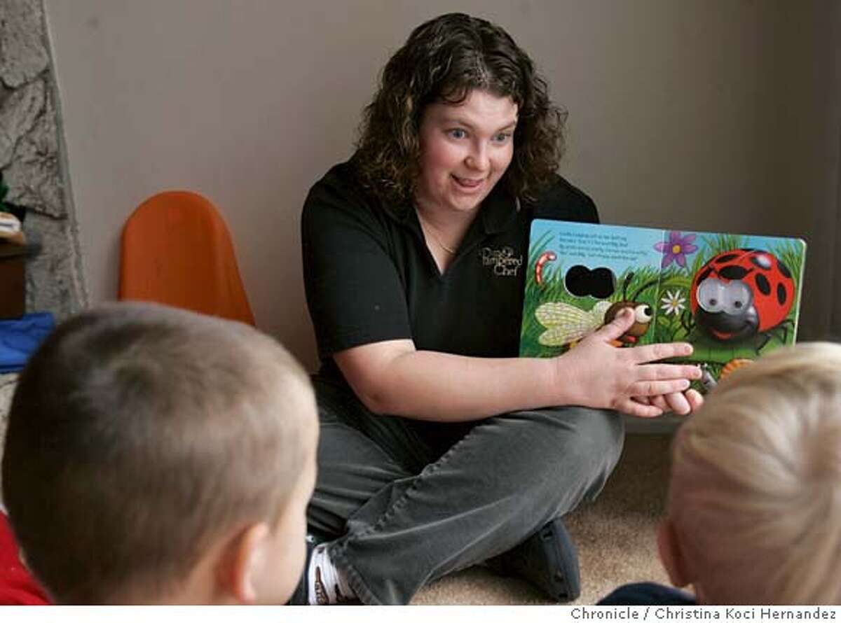 Egbers reads a book to the kids in her daycare before she puts them down for a nap. (Children to remianed unidentified.)Jenni Egbers, 30, who is a family child care provider in Concord who stays open 24 hours.5 .(CHRISTINA KOCI HERNANDEZ/CHRONICLE) CHRONICLE Photos by CHRISTINA KOCI HERNANDEZ