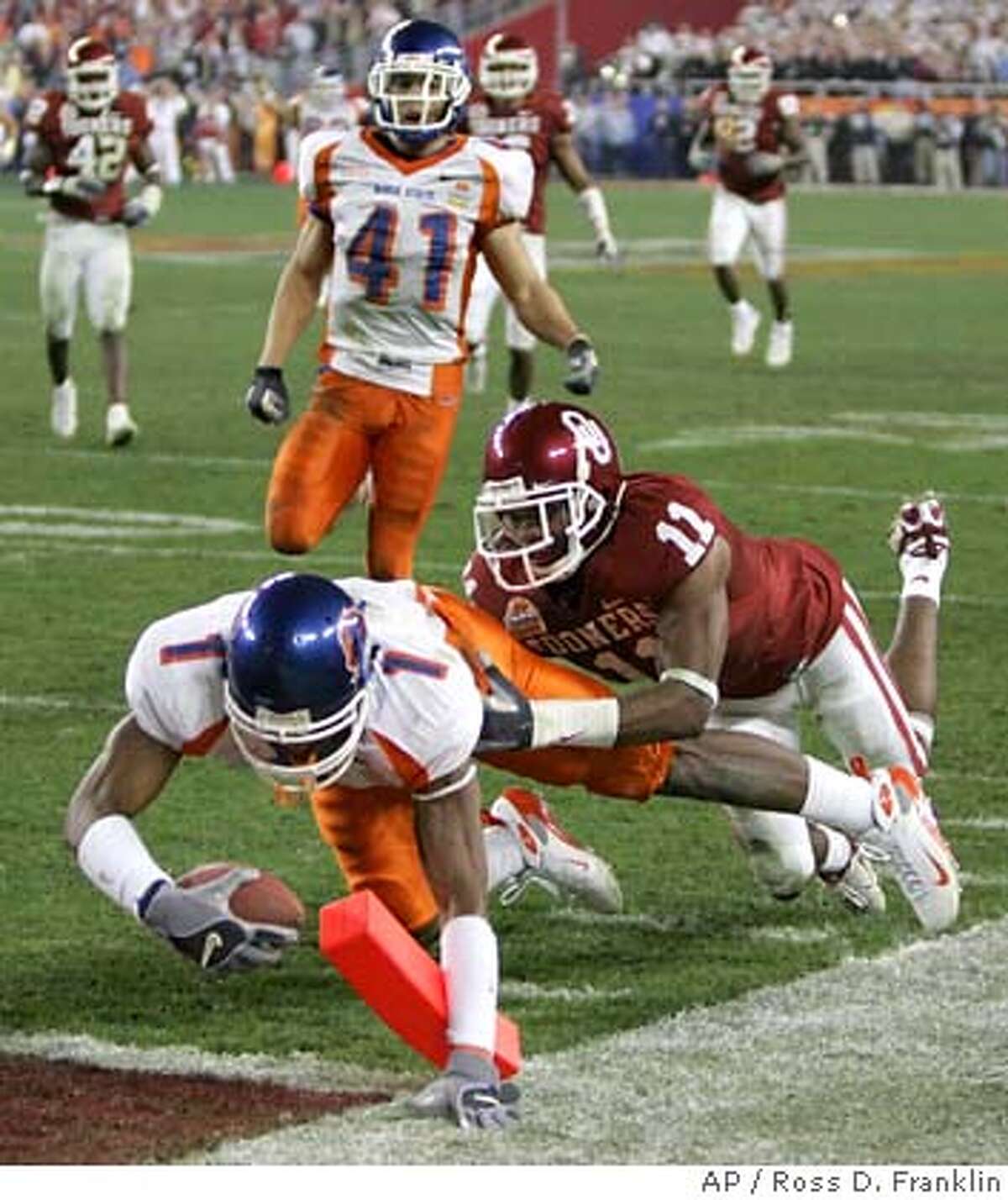 Boise State's Jerard Rabb (1) dives for a touchdown ahead of Oklahoma's Lendy Holmes (11) during the fourth quarter of the Fiesta Bowl college football game, Monday, Jan. 1, 2007, in Glendale, Ariz. (AP Photo/Ross D. Franklin)