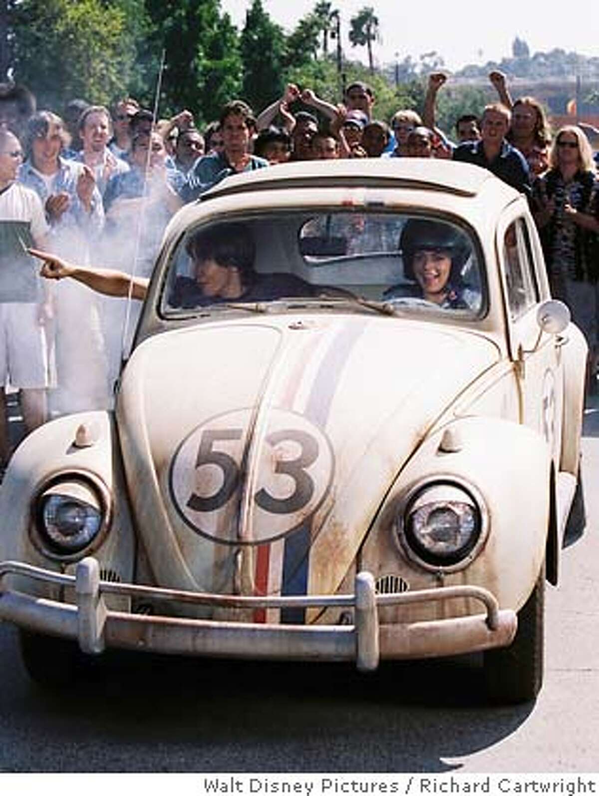 In this photo provided by Walt Disney Pictures, Justin Long (left), Lindsay Lohan (right) takes a ride in Herbie, a Volkswagen Bug that can drive itself, in 'Herbie Fully Loaded' (AP Photo/Walt Disney Pictures/ Richard Cartwright)