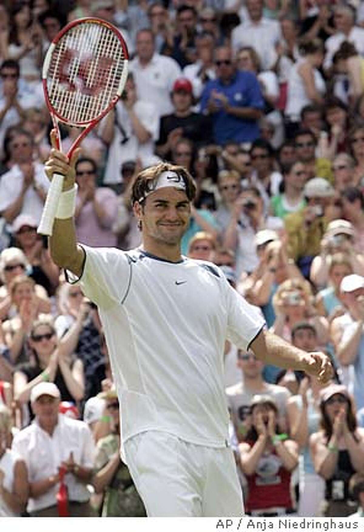 Switzerland's Roger Federer waves to the crowd after defeating France's Paul-Henri Mathieu during their first round match at the Wimbledon Championships in WImbledon Monday, June 20, 2005. (AP Photo/Anja Niedringhaus)
