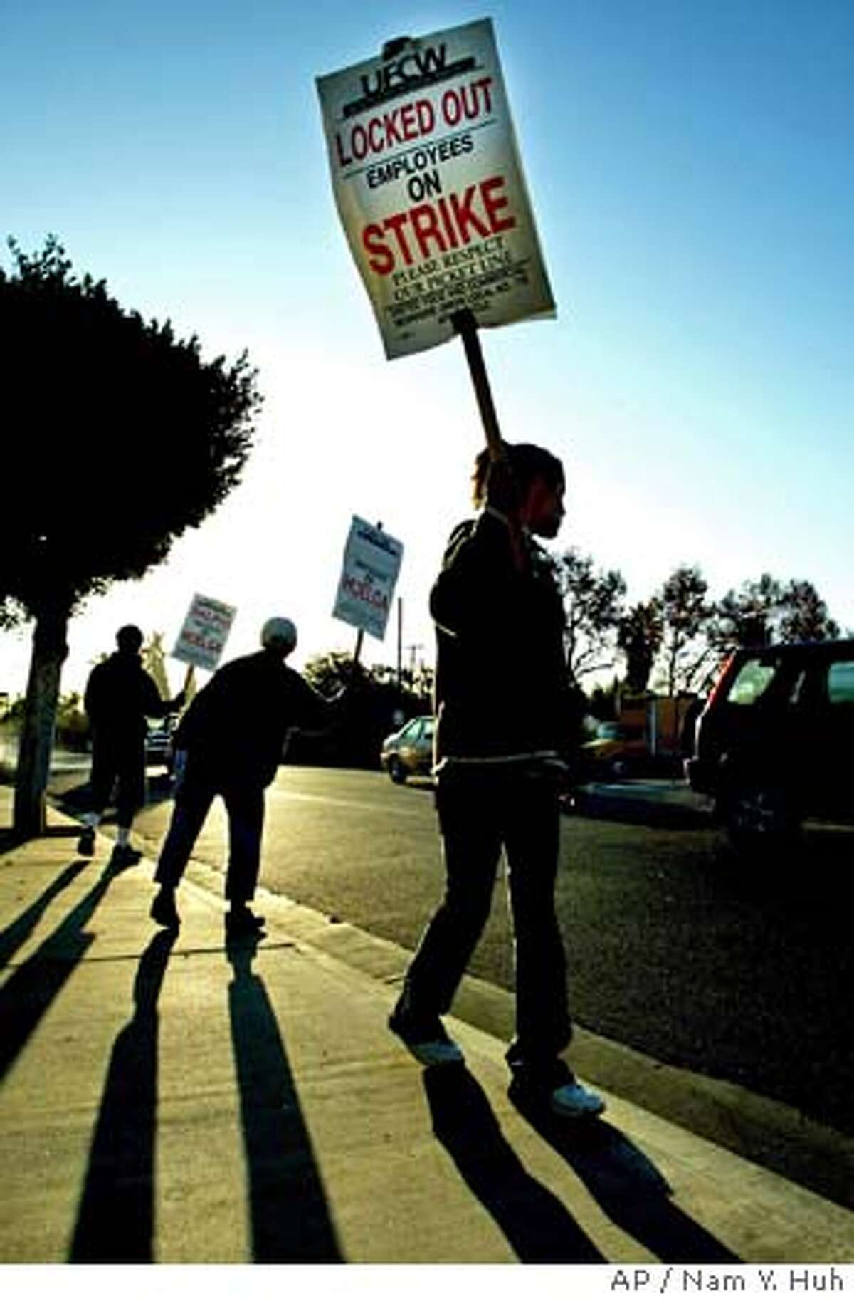 A group of clerks form a picket line outside a Ralphs grocery store Monday, Oct. 13, 2003, in Los Angeles. More than 70,000 Southern California grocery clerks went on strike late Saturday after lengthy negotiations ended between union representatives and grocery store officials. (AP Photo/ Nam Y. Huh) A group of clerks form a picket line outside a Ralphs grocery store in Los Angeles. CAT RODRIZE IS CQ
