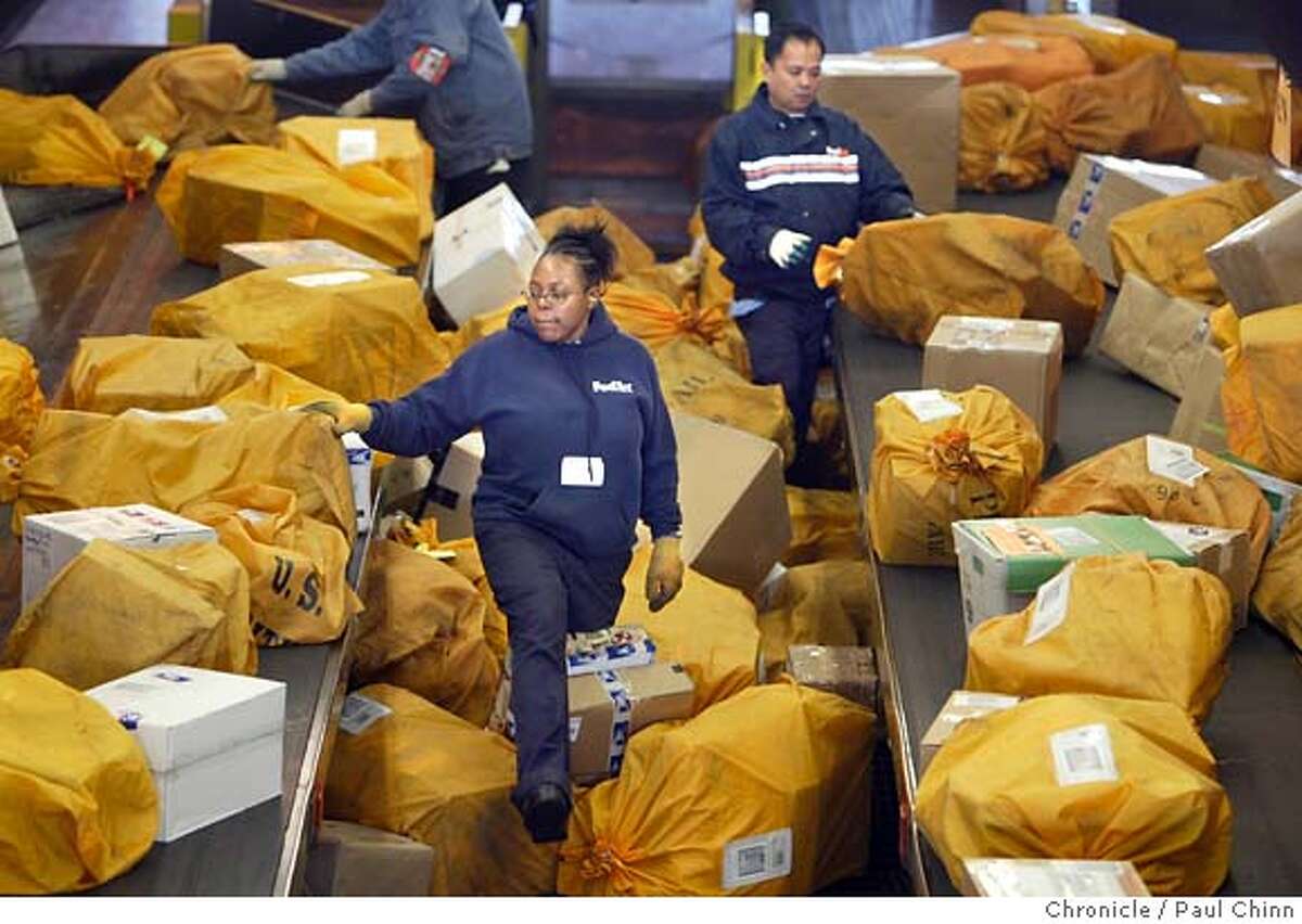 Sorters organize mountains of US Postal Service packages. USPS is Federal Express' largest client. The Federal Express sorting facility at Oakland International Airport on 12/17/04 in Oakland, CA. PAUL CHINN/The Chronicle MANDATORY CREDIT FOR PHOTOG AND S.F. CHRONICLE/ - MAGS OUT