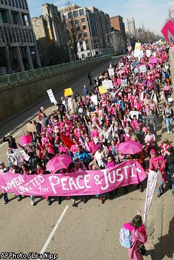 A protester holding a placard saying U.S. war machine: real threat to  peace at a rally against war with Russia sponsored by multiple groups  including CODEPINK: Women for Peace, Black Alliance for