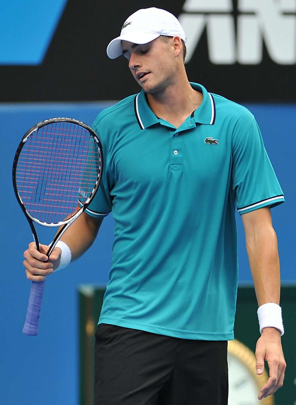 John Isner of the US gestures during his men's singles match against Feliciano Lopez of Spain on the fifth day of the Australian Open tennis tournament in Melbourne on January 20, 2012. Lopez won 6-3. 6-7. 6-4. 6-7. 6-1. . AFP PHOTO/NICOLAS ASFOURI IMAGE STRICTLY RESTRICTED TO EDITORIAL USE STRICTLY NO COMMERCIAL USE (Photo credit should read NICOLAS ASFOURI/AFP/Getty Images)