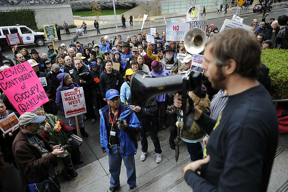 Jed Holtzman of Move to Amend gives the crowd details on other Occupy actions happening around the city. In conjunction with Occupy West, Protestors gather in front of the 9th Circuit Court of Appeals in San Francisco to demand a change to the "Citizens United" Supreme Court ruling. Friday January 20th, 2011.