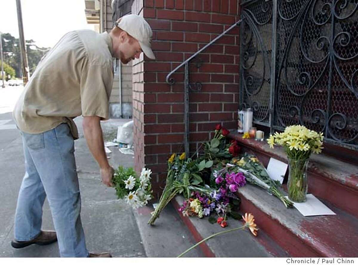Paul Wallace leaves a bouquet of flowers at the growing memorial shrine at the Faibish home. Neighbors gathered in front of 711 Lincoln Way on 6/4/05 in San Francisco, Calif. to talk about Friday's tragic dog mauling death of 12-year-old Nicholas Faibish by his family's two pet pit bulls Ella and Rex. PAUL CHINN/The Chronicle
