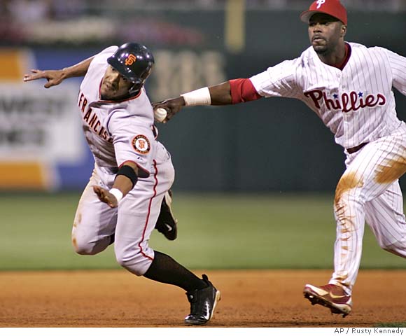 San Francisco Giants second baseman Jason Ellison, right, throws