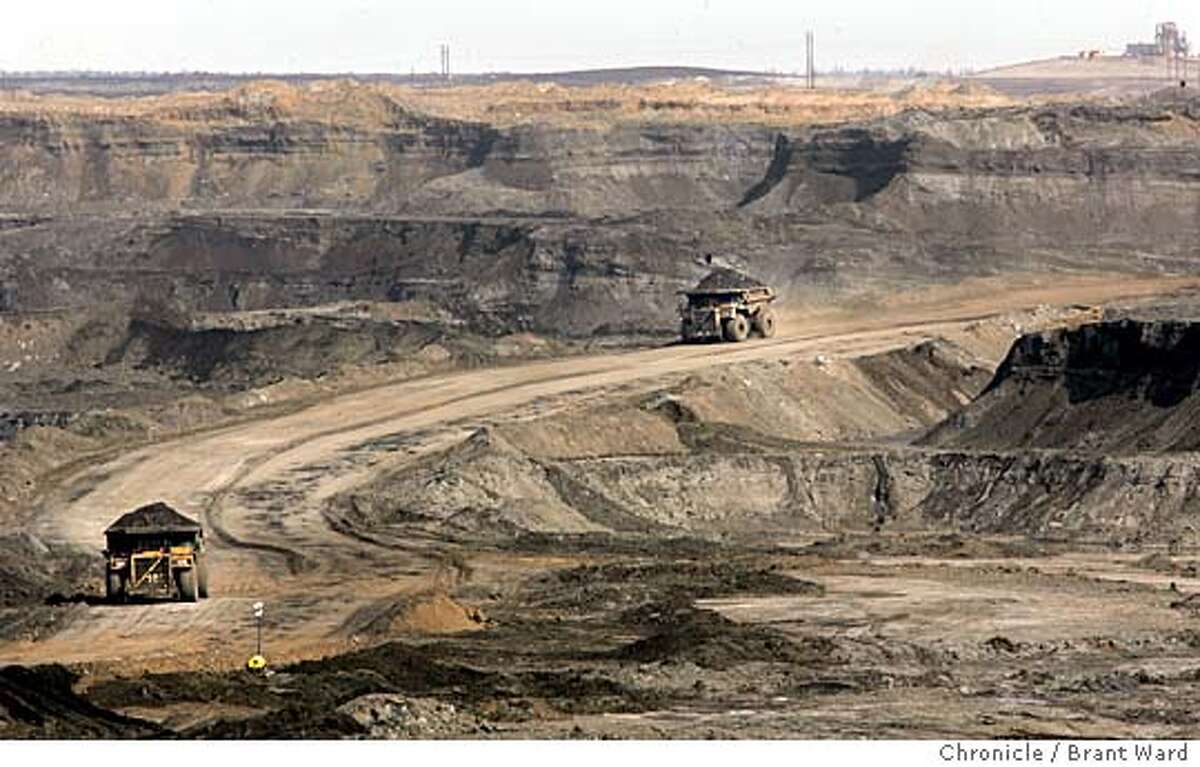 At the Chevron oilsands project north of Fort McMurray, giant earth haulers drive into the canyon created by the strip mining process. They work 24 hours a day carrying the raw dirt coated with oilsands out of the manmade canyon. The oil sands area of Alberta, Canada is perhaps the answer to Canada and America's energy needs for the next 40 years. The oil is attached to tiny grains of sand and dirt and is being mined all around the city of Fort McMurray. This has caused a "boomtown" atmosphere in the small town. Even with good salaries for workers at the oil sands, rents and home prices rival Northern California. Many of the "homeless" make over $30,000 a year, but still can't afford the high rents. The young workers go a little crazy on weekends at the local casino and bars...the famous mounties must patrol outside. This is a portrait of the oil sands and the town that is paying the price. Brant Ward 4/20/05