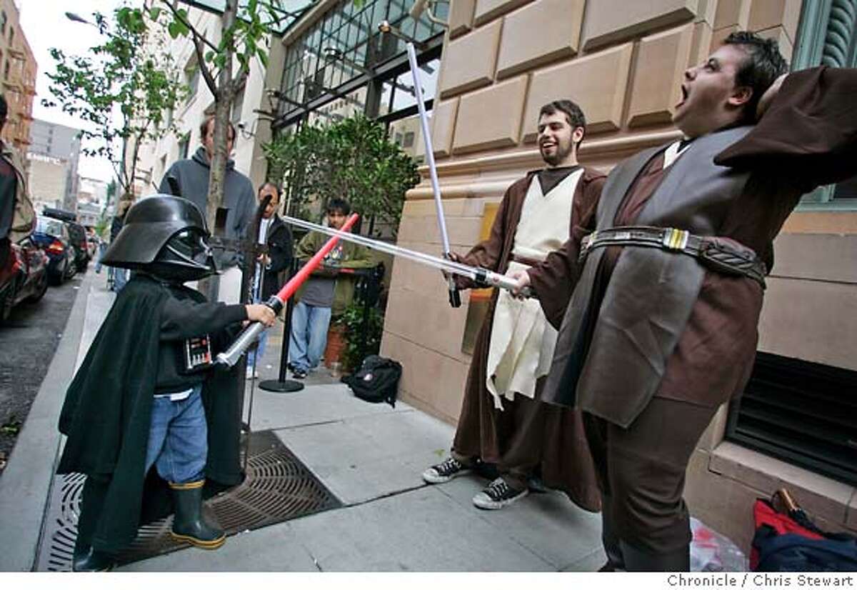 starwarslines236.jpg Event on 5/18/05 in San Francisco. Peter Loeber (center), 21, SF, and David McCloughan (right), 21, SF, battle a young Darth Vader played by Giovanni Barreto, 4, as they await the midnight showing of "Star Wars: Episode III - Revenge of the Sith" at the AMC Van Ness 14 Theater in SF. Giovanni is a "third generation Star Wars fan," according to his father Enrique Barreto, who was attending the movie with Giovanni and his grandfather. In anticipation of the Star Wars fanatics camping out outside of theaters hours before the first screening of Revenge of the Sith. Chris Stewart / The Chronicle MANDATORY CREDIT FOR PHOTOG AND SF CHRONICLE/ -MAGS OUT