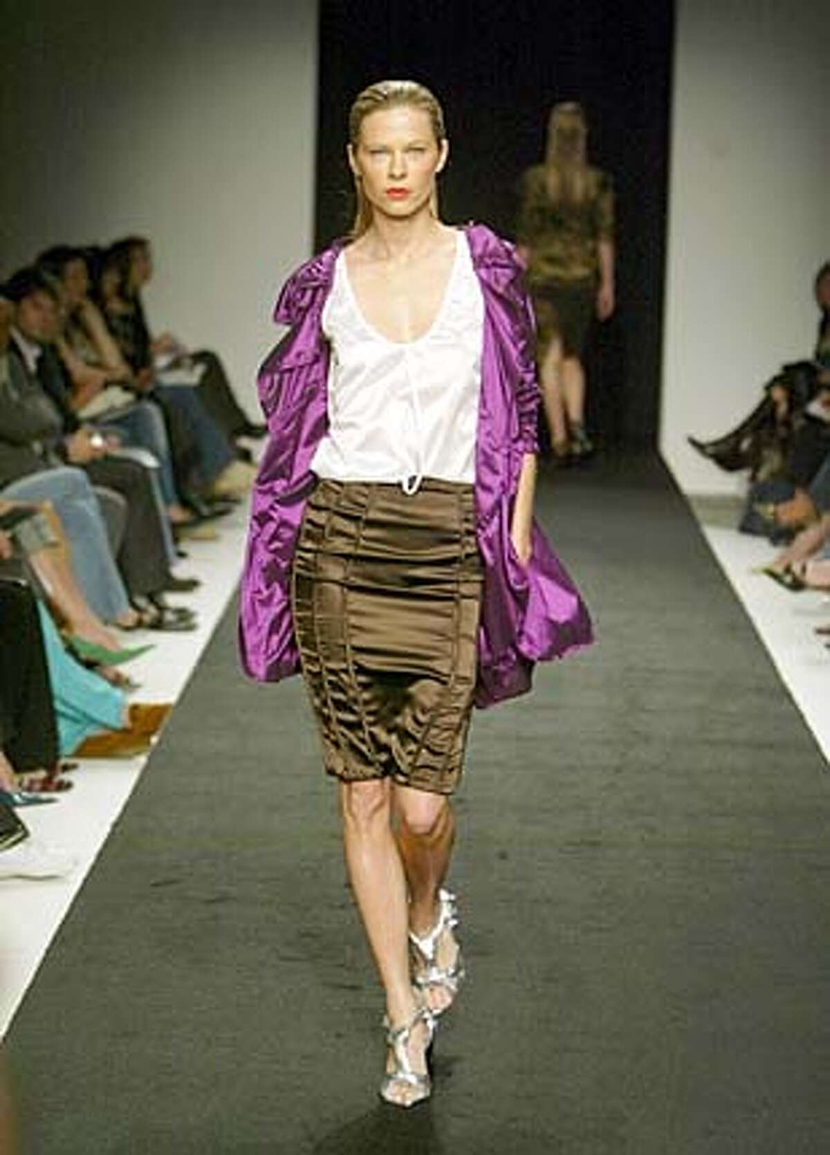 Juan Carlos Obando's stretch micro taffetta jacket, pencil skirt and tank, and silver metallic knotted goatskin stiletto sandals, at LA fashion week, oct 2004 Living#Living#Chronicle#11/14/2004#ALL#Advance#XX#0422452777