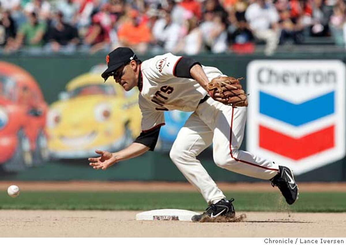 GIANTS303.jpg_ Giants short stop Omar Vizquel attempts to one hand a ground ball from Washington Nationals Jamey Carroll. Washington won the game 11 to 8. By Lance Iversen/San Francisco Chronicle MANDATORY CREDIT PHOTOG AND SAN FRANCISCO CHRONICLE.