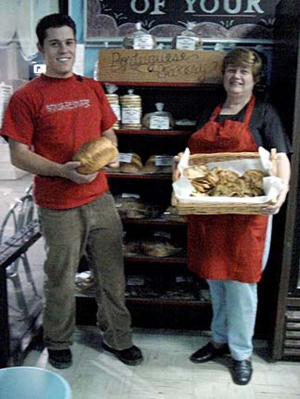 Mary Couto and her son, Gilbert, show off breads from the Portuguese Bakery in Santa Clara.