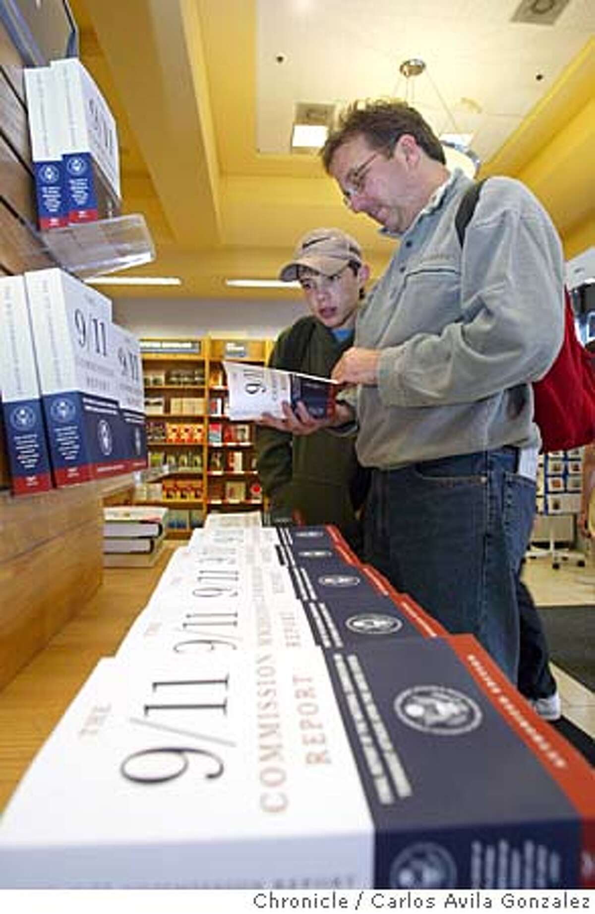 911REPORT_002_CAG.JPG Bill Personke, and his son, Dolan, 15, leaf through a copy of the 9/11 Commission Report at Borders Book Store in San Francisco, Ca., on Thursday, July 22, 2004. This book, details the commission's findings in the investigations following the 9/11 hijackings and the ensuing terrorism. Photo taken on 07/22/04, in San Francisco, Ca. Photo by Carlos Avila Gonzalez/The San Francisco Chronicle Ran on: 09-19-2004 Bill Personke and his son, Dolan, 15, skim the report at San Franciscos Borders in July. Datebook#Datebook#Chronicle#11/12/2004#ALL#Advance##0422211109