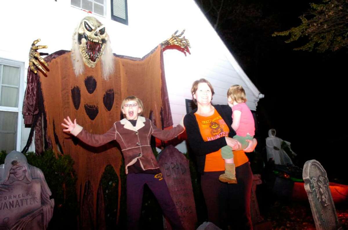 "Queen of Halloween" Karen Hasterok and daughters Quinn Hasterok, 2, and Alexandra Buss, 10, left, stalk the night at their Old Greenwich home on Wendel Place Thursday evening, Oct, 29, 2009. The Hasterok Halloween fever has spread and they now do traditional decorating battle with neighbors led by Andrew Buss (unrrelated to Alexandra.) The verdict is still out on who won this year's contest.