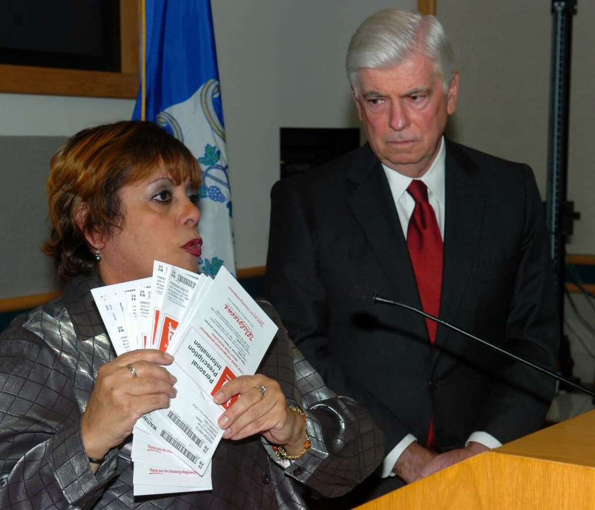 Sen. Christopher Dodd listens as Freeda Fretz, of Bridgeport, talks about her struggles with health care costs during a forum on health care reform legislation, held at Bridgeport Hospital, in Bridgeport, Conn. on Friday, Oct. 30th, 2009. Fretz, a cancer survivor, holds receipts for just a month's worth of medicine that she has paid for to treat her chronic asthma.