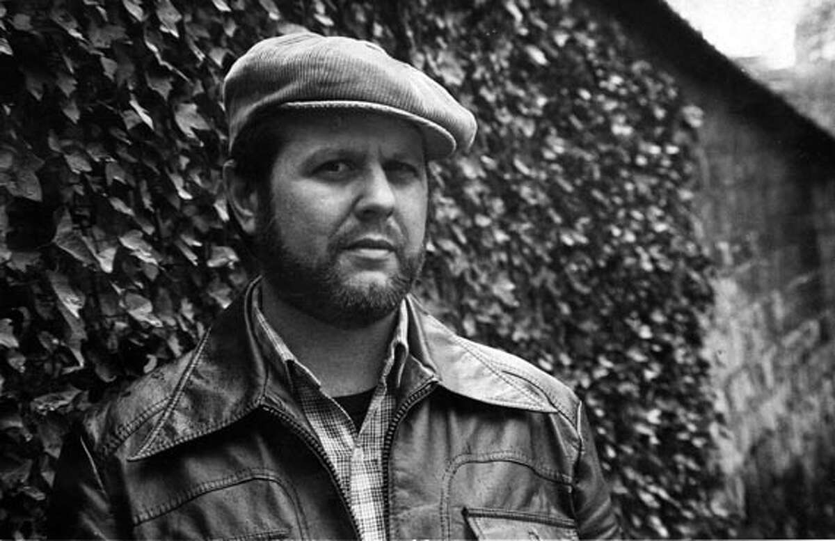 Photo of "Bob Avakian in front of the Wall of Communards in Paris, 1981."