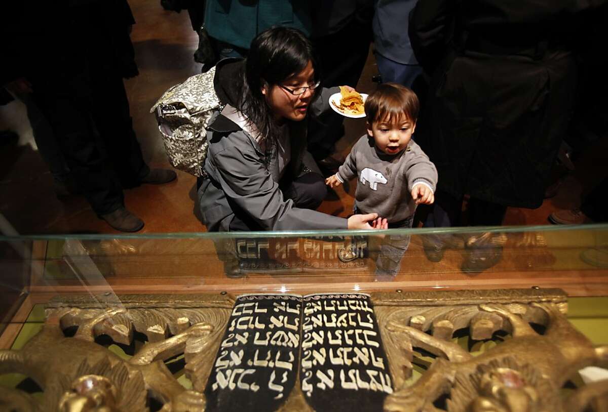 Helen Bobell, of Oakland, shows her son Kai, 22 months, a 20th century Torah Ark pediment at the re-opening of Magnes Museum in Berkeley, Calif., Sunday, January 22, 2012.