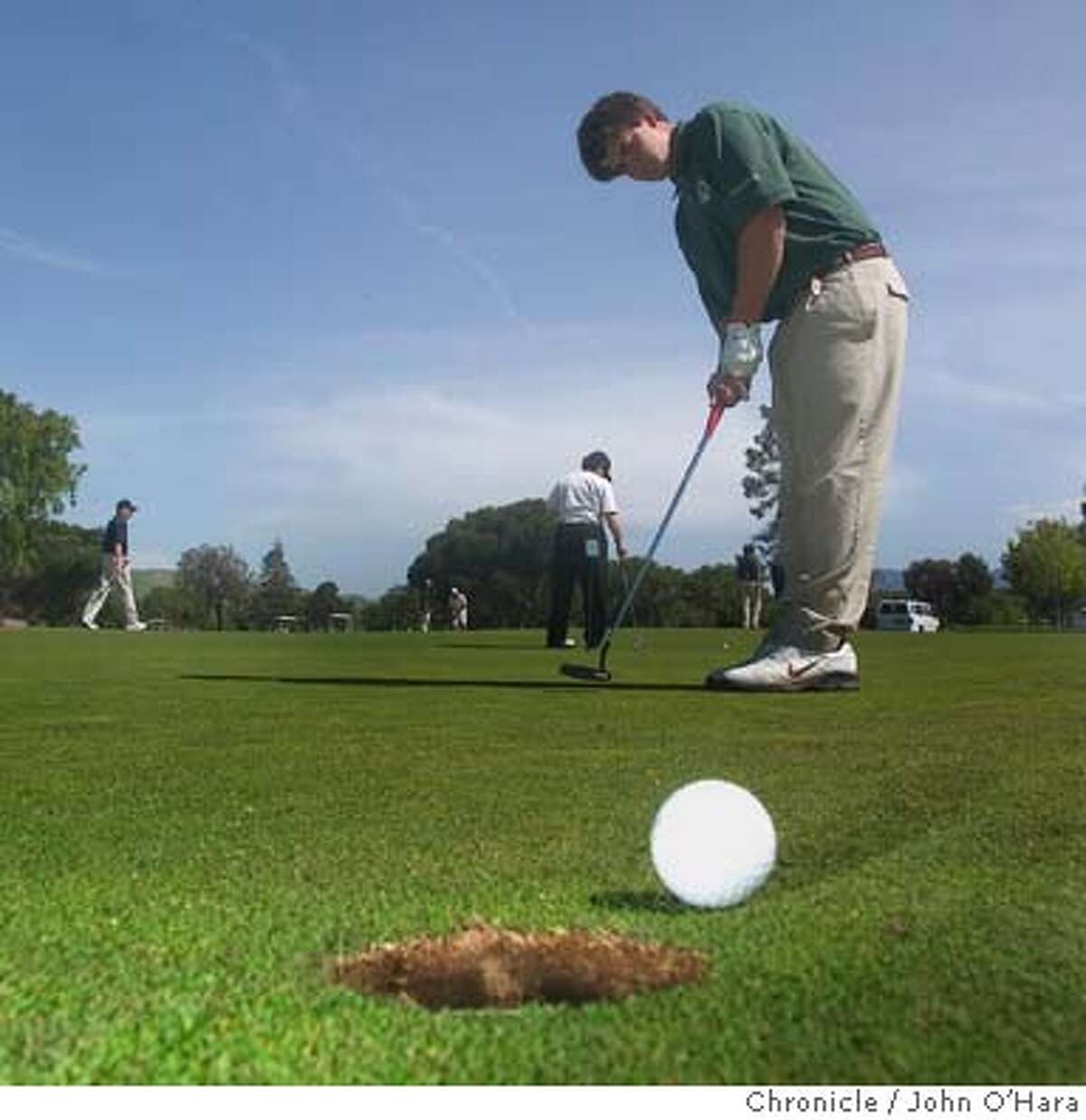 Diablo Creek Golf Course, Concord, CA. Roberto Galletti, practices on the putting green DeLasalle Golf Team just before a match Photo/ John O'Hara