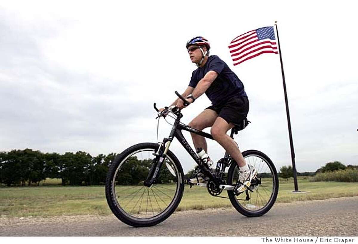 President Bush rides his bike on his ranch in Crawford, Texas, Monday, July 26, 2004. (AP Photo/The White House, Eric Draper, HO) Ran on: 07-27-2004 President Bush, suffering from an achy knee, now prefers mountain biking to jogging. Insight#Insight#Chronicle#10/24/2004#ALL#Advance##0422216885