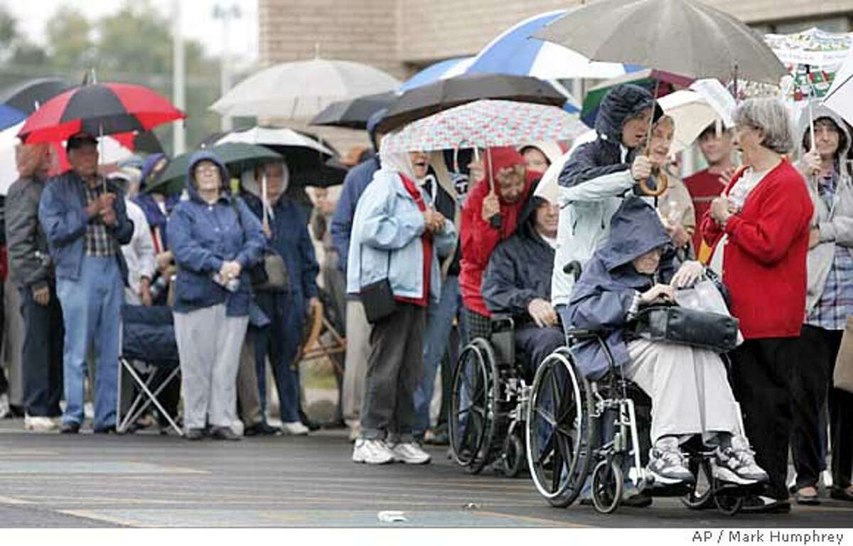 People wait in the rain outside the Lentz Public Health Center to receive the flu vaccine Monday, Oct. 18, 2004, in Nashville, Tenn. People lined up as early as three hours before the clinic opened to receive one of the 1,200 doses being given Monday. (AP Photo/Mark Humphrey) Ran on: 10-19-2004 People line up in the rain for flu shots outside the Lentz Public Health Center in Nashville, Tenn. Ran on: 10-19-2004 People line up in the rain for flu shots outside the Lentz Public Health Center in Nashville, Tenn.