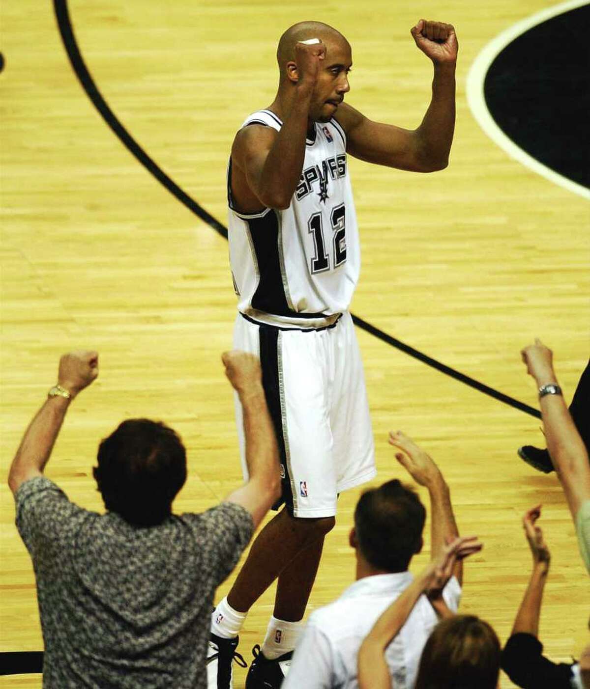 Spurs Bruce Bowen celebrates the Spurs narrow vistory over the Lakers as fans react also during Game 5 of the Western Conference Semifinals at the SBC Center in San Antonio, TX Tuesday May 13, 2003. PHOTO BY TOM REEL/STAFF