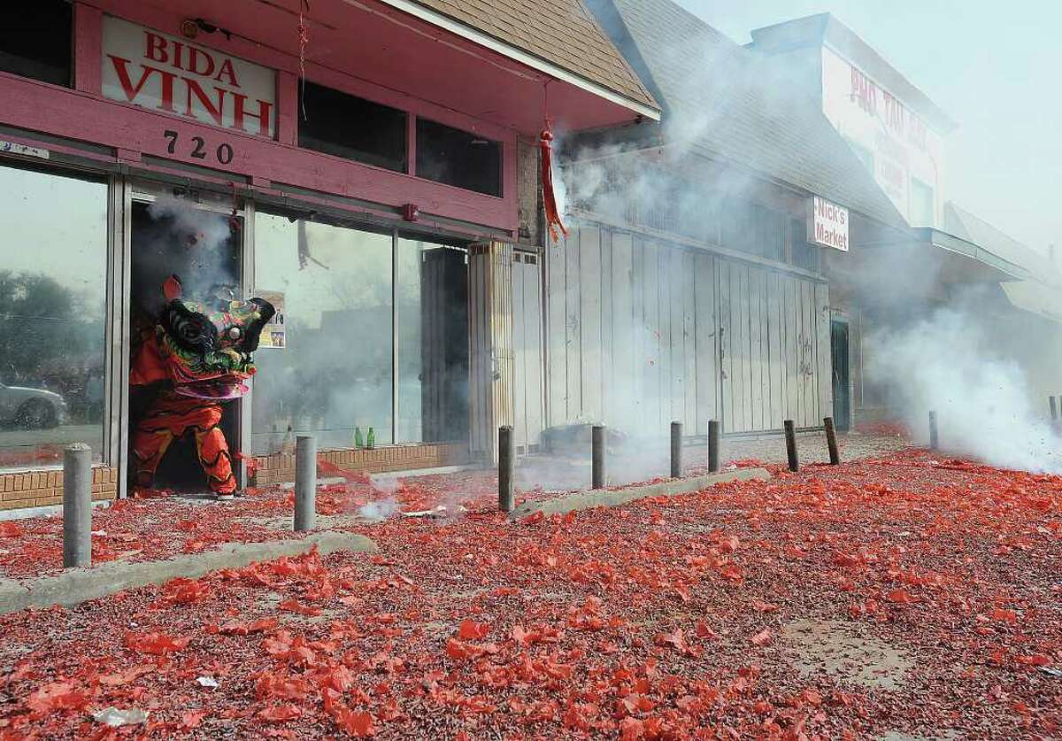 Dragon dancers perform in and out of several Vietnamese businesses in Port Arthur on Monday to celebrate the new year. Once inside, the dragon searches for a lucky envelope filled with money. Photo taken Monday, January 23, 2012 Guiseppe Barranco/The Enterprise