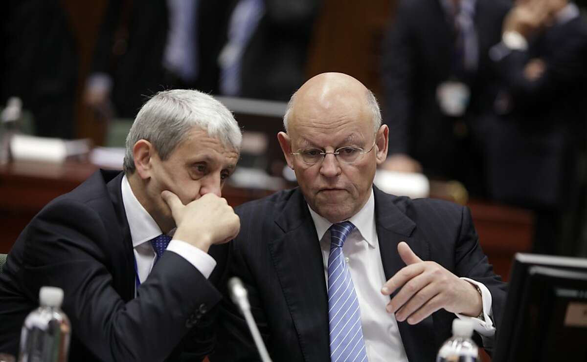 Slovakian Foreign Minister Mikulas Dzurinda, left, speaks with Dutch Foreign Minister Uri Rosenthal during a meeting of EU foreign ministers at the EU Council building in Brussels on Monday, Jan. 23, 2012. EU foreign ministers are set to impose an embargo on Iranian oil to pressure the country to resume talks on its nuclear program. (AP Photo/Virginia Mayo)