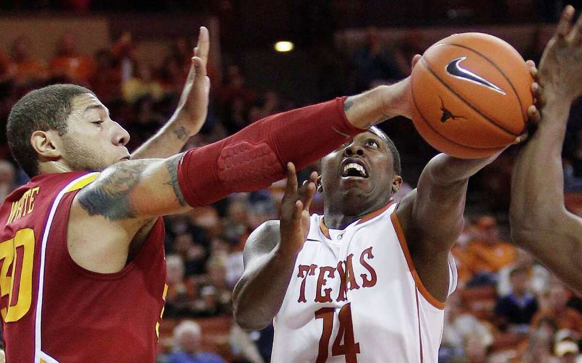 Texas' J'Covan Brown (14) drives as Iowa State's Royce White, left, defends during the second half of an NCAA college basketball game, Tuesday, Jan. 24, 2012, in Austin.