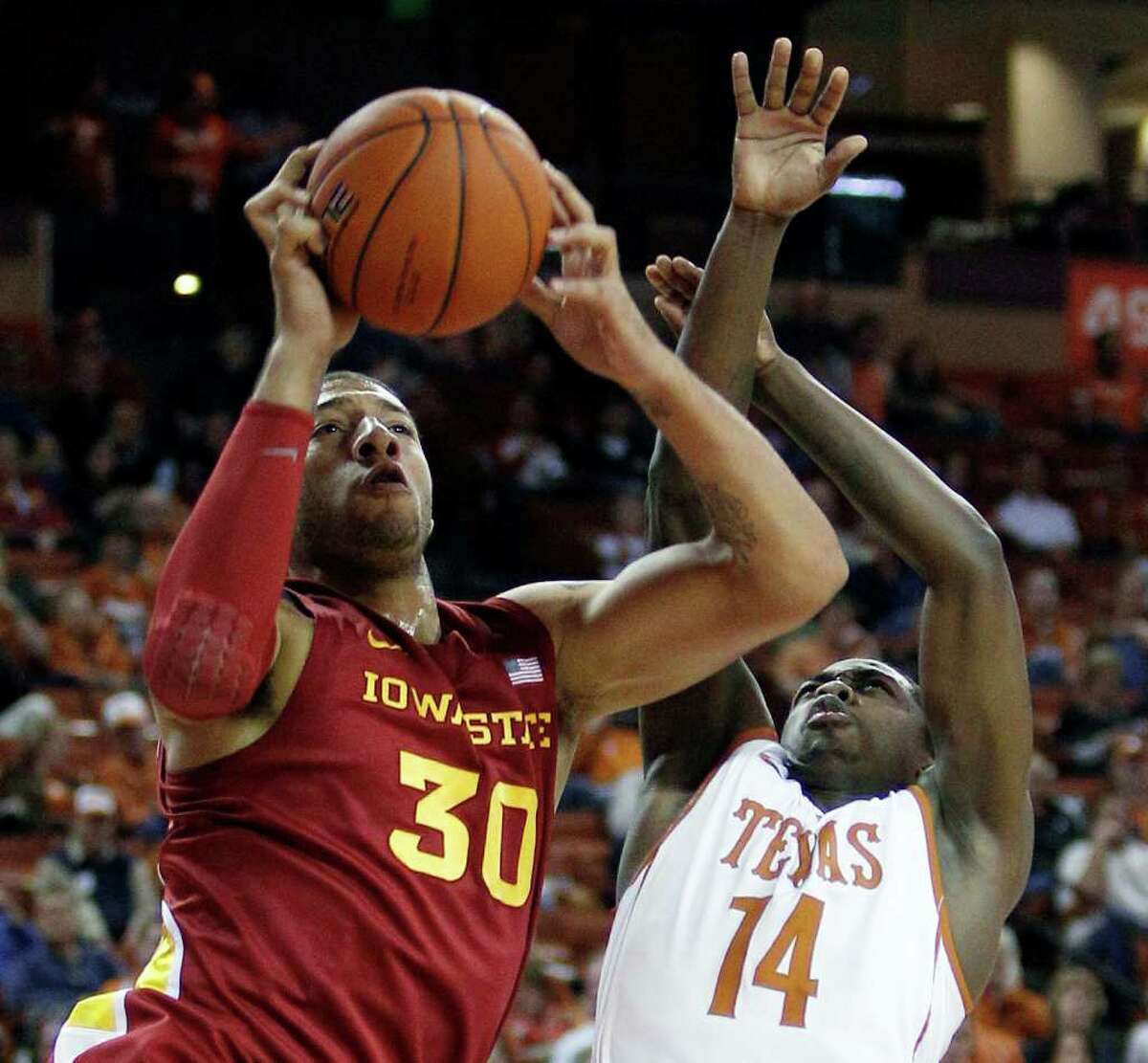 Iowa State's Royce White (30) is defended by Texas' J'Covan Brown (14) during the first half of an NCAA college basketball game, Tuesday, Jan. 24, 2012, in Austin.