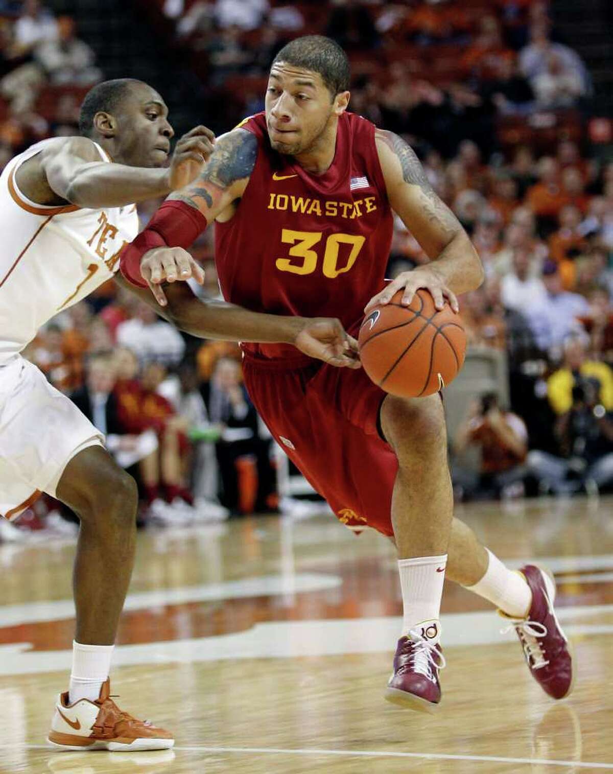 Iowa State's Royce White (30) drives past Texas' Sheldon McClellan (1) during the first half of an NCAA college basketball game, Tuesday, Jan. 24, 2012, in Austin.