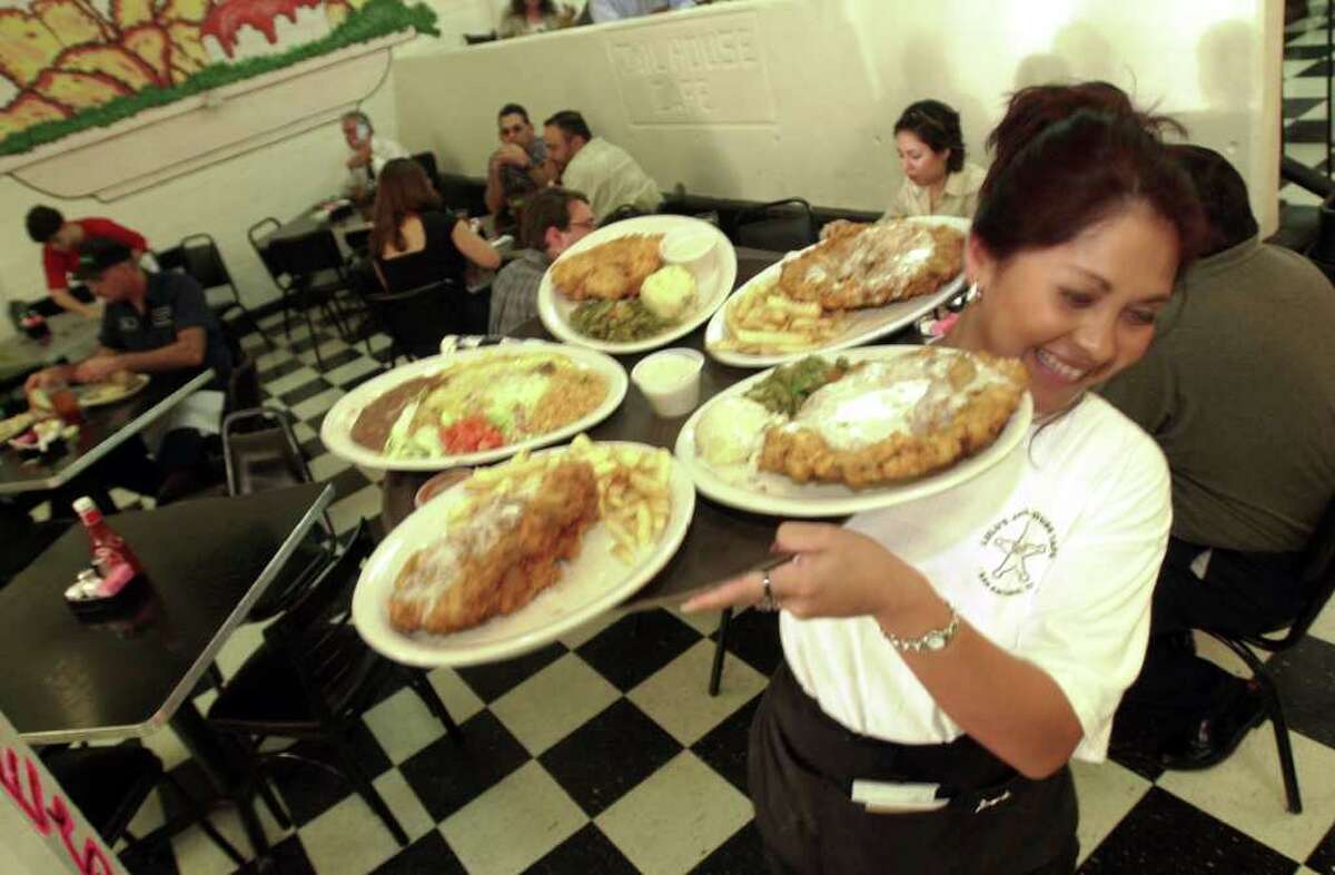 A letter writer responds to a restaurateur's complaint about stingy tips by saying he tips "according to the service rendered." Here, a server at the Jailhouse Cafe hustles by with a tray of chicken-fried steaks.