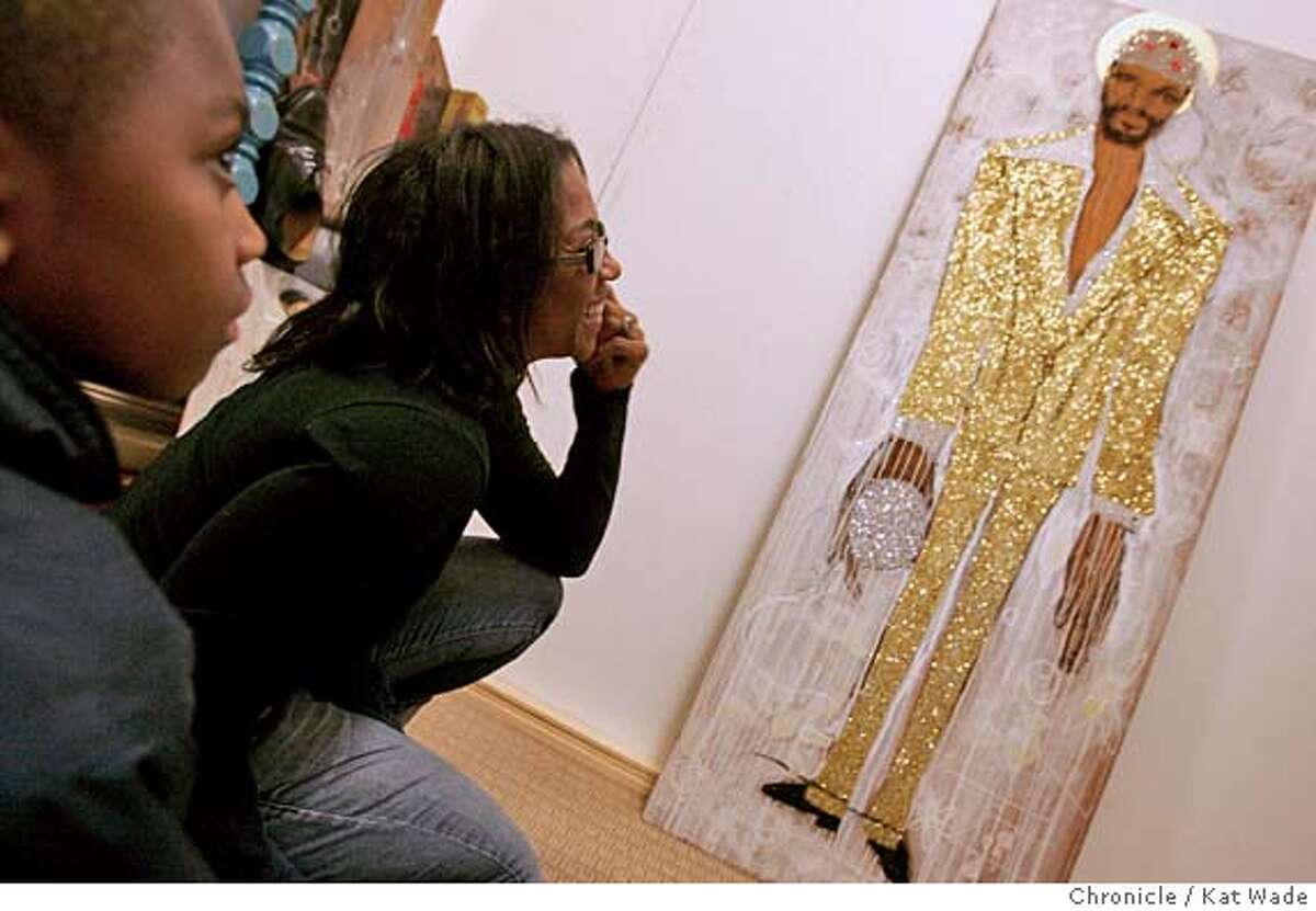 TROUBLEMAN02_145_KW.jpg On 3/31/05 in Oakland with her son, Easweh, 9, Bridget Goodman looks over her glitter and paint portrait titled, "Marvin," one of 14 installations in the new multi-media exhibit, "Troubled Man," that looks at the life and times of rhythm and blues legend Marvin Gaye. in both a current context as well as his role in history. The exhibit opens Saturday April 2nd and runs to May 28 at the African American Museum and Library in Oakland. Kat Wade/ The Chronicle MANDATORY CREDIT FOR PHOTOG AND SF CHRONICLE/ -MAGS OUT