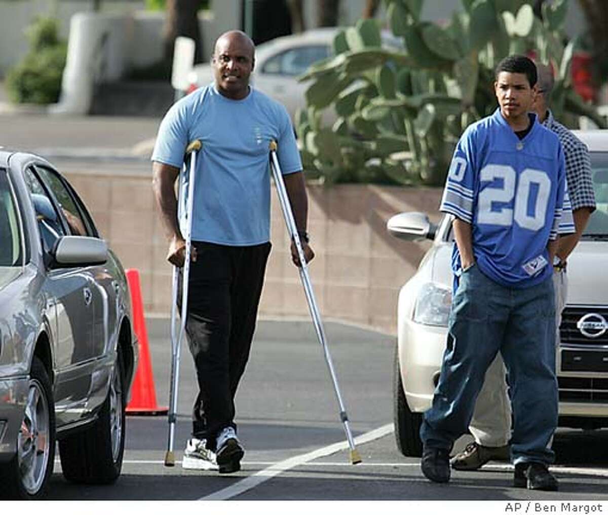 San Francisco Giants' Barry Bonds returns to spring training camp Tuesday, March 22, 2005, in Scottsdale, Ariz. Bonds has returned to Giants camp for rehabilitation since a second arthroscopic surgery on his right knee last week. At right is his son, Nikolai Bonds. (AP Photo/Ben Margot)