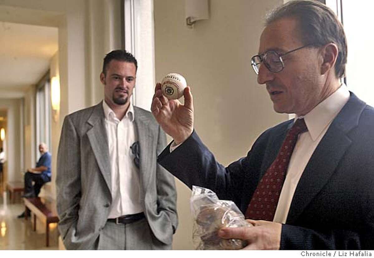 BALL_008_LH.jpg Attorney Daniel A. Horowitz holds a ball (not the ball in question) and a chew bone to demonstrate how the ball would have bounced off a chin. The court has ordered Steven Williams, in background, not to sell Barry Bonds' 700th homerun baseball until next Friday's hearing. San Francisco on 9/29/04 by LIZ HAFALIA One time use Metro#Metro#Chronicle#9/30/2004#ALL#5star#b4#0422382931