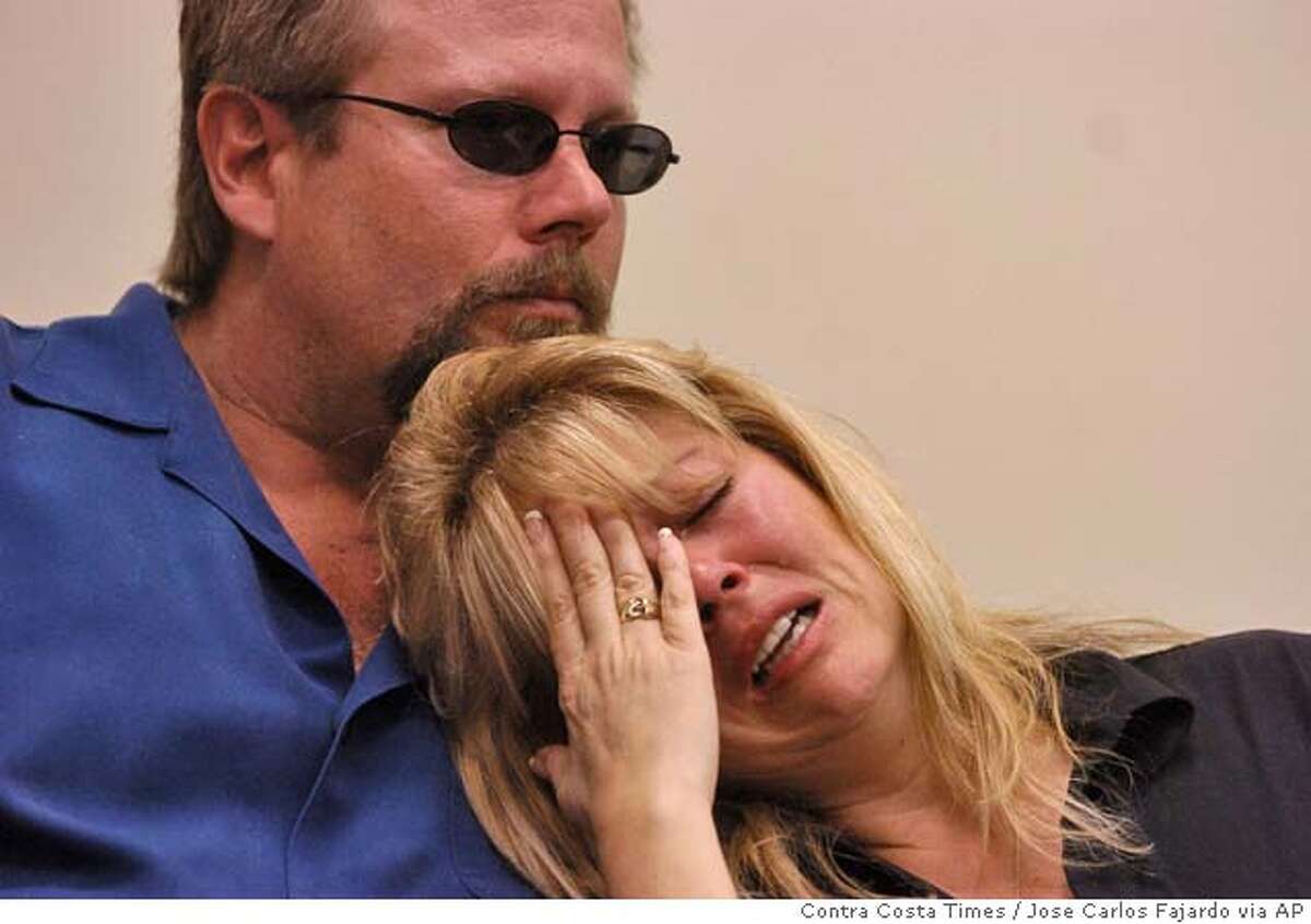 Debbie Smith, mother of Matthew William Carrington, is consoled by her husband, Greg Smith, during a press conference at the Chico Police Department, Thursday, March 3, 2005, in Chico, Calif., where it was announced that four California State University fraternity members were charged Wednesday with involuntary manslaughter in the death of 21-year-old Carrington. (AP Photo/Contra Costa Times, Jose Carlos Fajardo) MAGS OUT, , NO ARCHIVEING, TV OUT, INTERNET OUT, SF BAY AREA MUST CREDIT
