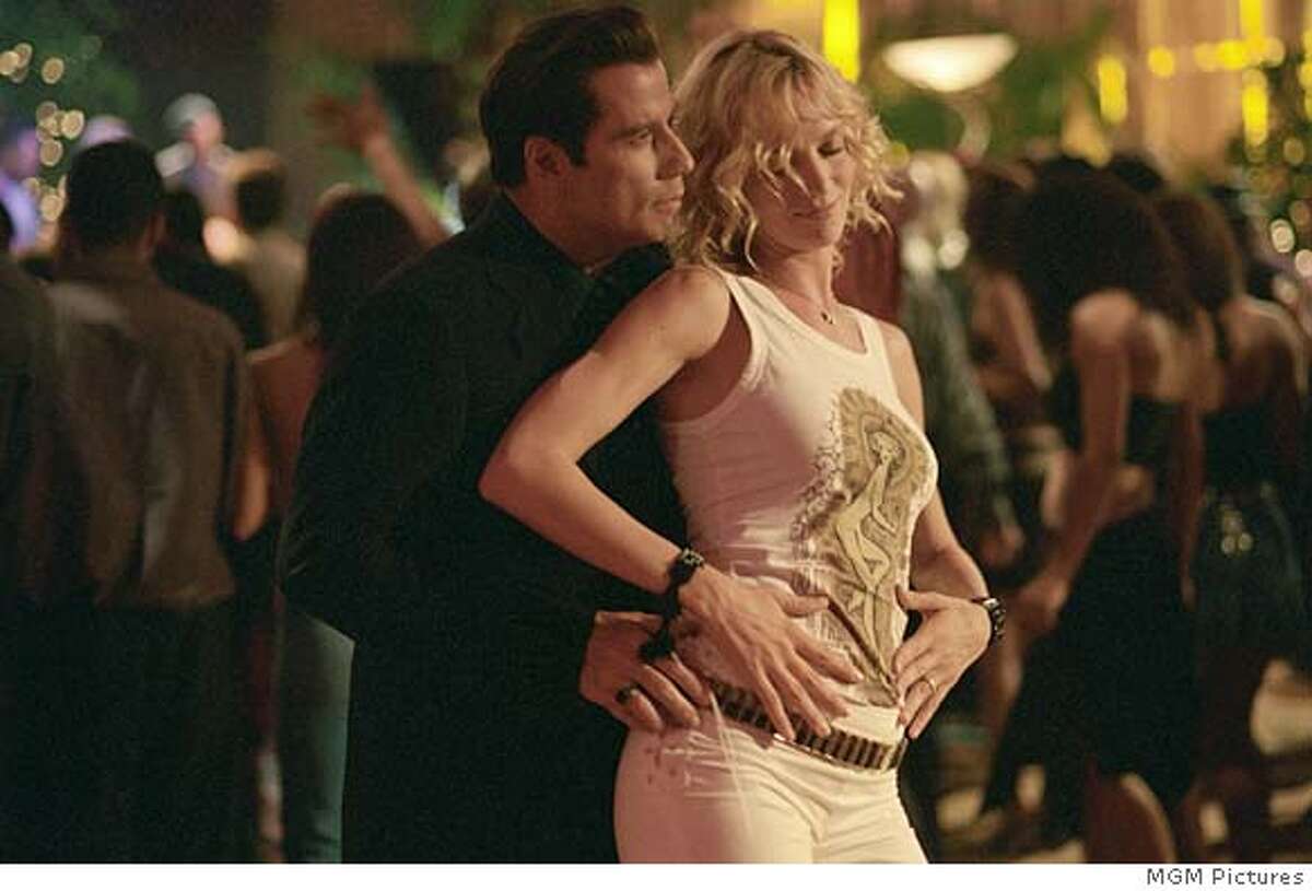 BECOOL04 Chili (JOHN TRAVOLTA) and Edie (UMA THURMAN) hit the dance floor in MGM Pictures� comedy BE COOL. CR: Ron Phillips