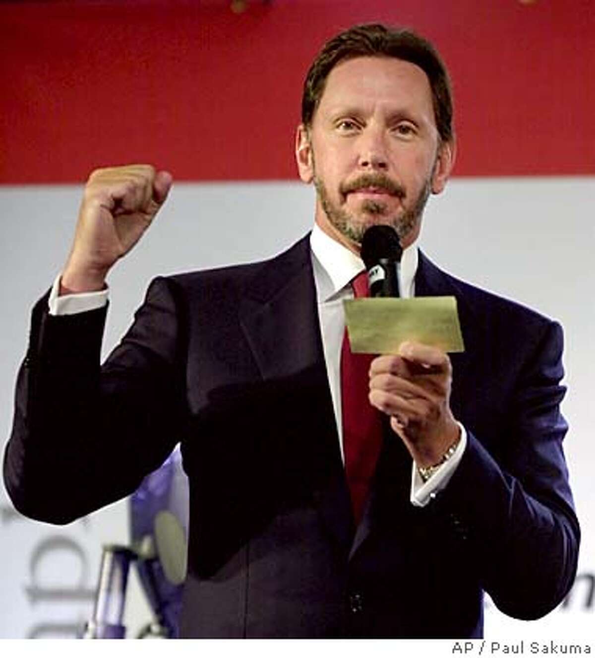 ** FILE ** Oracle Corp. CEO Larry Ellison clenches his fist during a news conference at Oracle's headquarters in Redwood City, Calif., June 28, 2000. A federal judge on Thursday, Sept. 9, 2004, rejected the government's bid to block Oracle Corp.'s $7.7 billion takeover bid for rival PeopleSoft Inc. on grounds that a combination between the business software makers would throttle competition in a narrow market niche. (AP Photo/Paul Sakuma, file) JUNE 28, 2000, PHOTO
