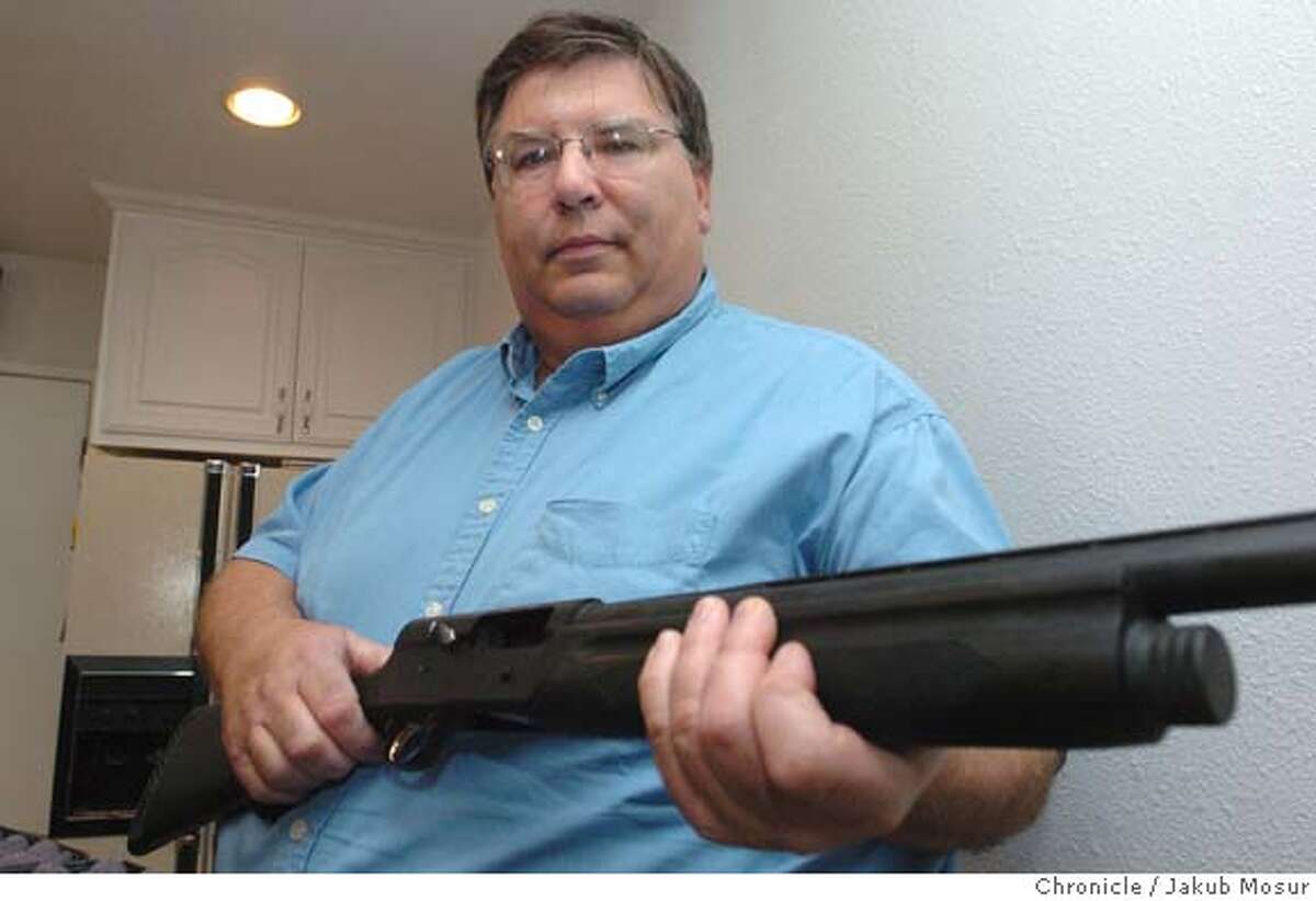 GUNS11_02_jmm.JPG Dennis Wolfe shows off his AR5 Browning Shotgun at his home in Fremont on Thursday, Feb. 10, 2005. Wolfe is calling on his fellow Fremont citizens to arm themselves following an annoucement by the police department that it will no longer respond to burglar alarms because 98 percent are false. Wolfe is handing out fliers through town and says he will work to recall the city council if they don't reverse the policy, which was enacted by the police chief. "I never bought this for self-defense," Wolfe said about his shotgun, "I got for skeet shooting." Event on 2/10/05 in Fremont. JAKUB MOSUR / The Chronicle MANDATORY CREDIT FOR PHOTOG AND SF CHRONICLE/ -MAGS OUT
