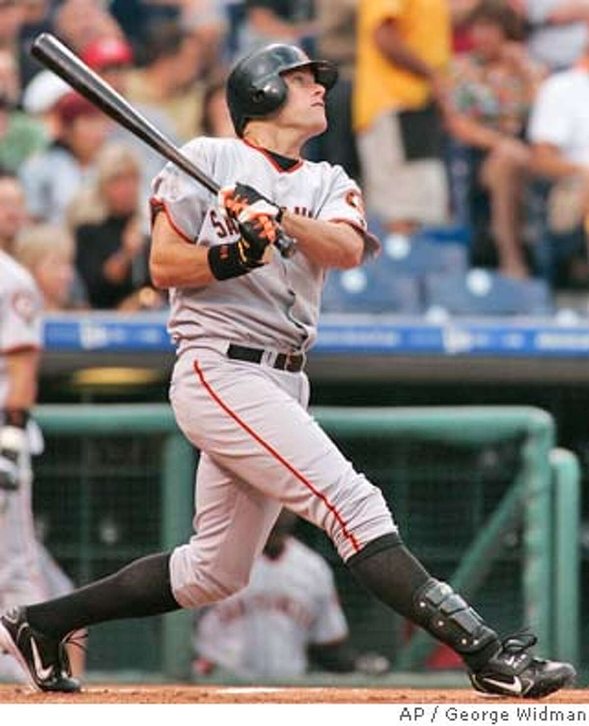 San Francisco Giants' J.T. Snow watches his two-run home run against the Philadelphia Phillies in the first inning Friday, Aug. 13, 2004, in Philadelphia. (AP Photo/George Widman)