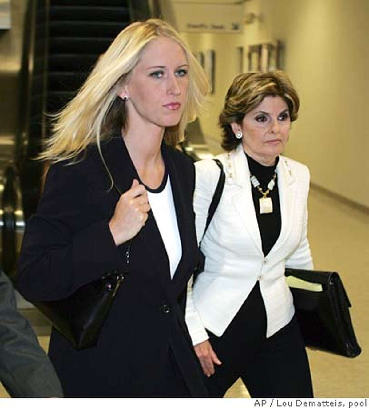 With her attorney Gloria Allred at right, Amber Frey leaves the courthouse after her second day of testimony during the Scott Peterson double murder trial in Redwood City, California, Aug. 11, 2004. (AP Photo/Lou Dematteis, pool) POOL PHOTO