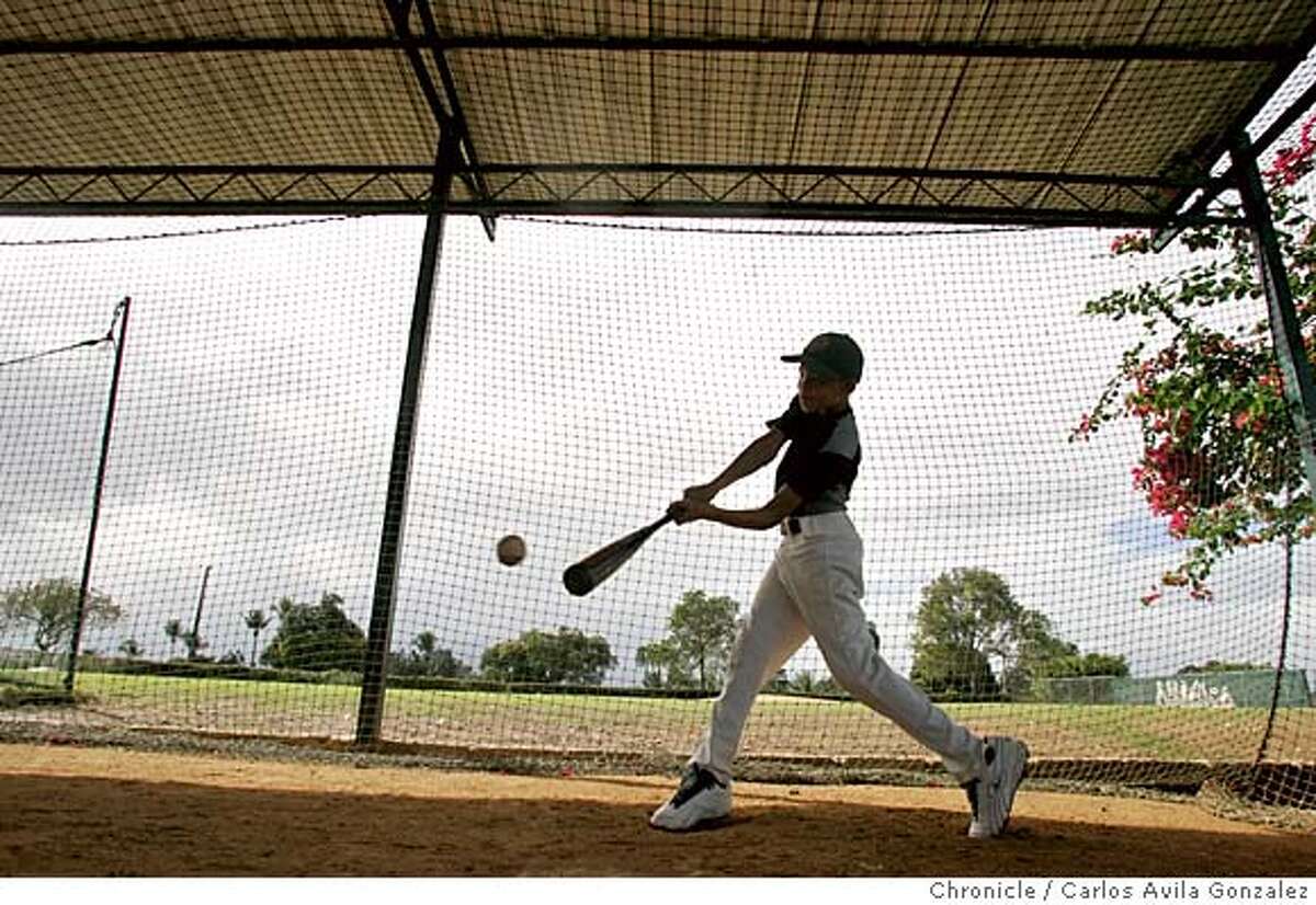 ACADEMIES18_002_CAG.JPG Johan Lantigua, 10, practices his swing at the Oakland Athletics Academy in La Victoria, Dominican Republic on Tuesday, January 11, 2005. Lantigua is the son of Varo Lantigua, who is one of the main coaches at the complex. Photo taken on 1/11/05, in La Victoria, Dominican Republic. The academy trains some 70 students every year, and has produced some of the best players in the majors from the Dominican Republic including, Miguel Tejada. Photo by Carlos Avila Gonzalez/The San Francisco Chronicle MANDATORY CREDIT FOR PHOTOG AND SF CHRONICLE/ -MAGS OUT