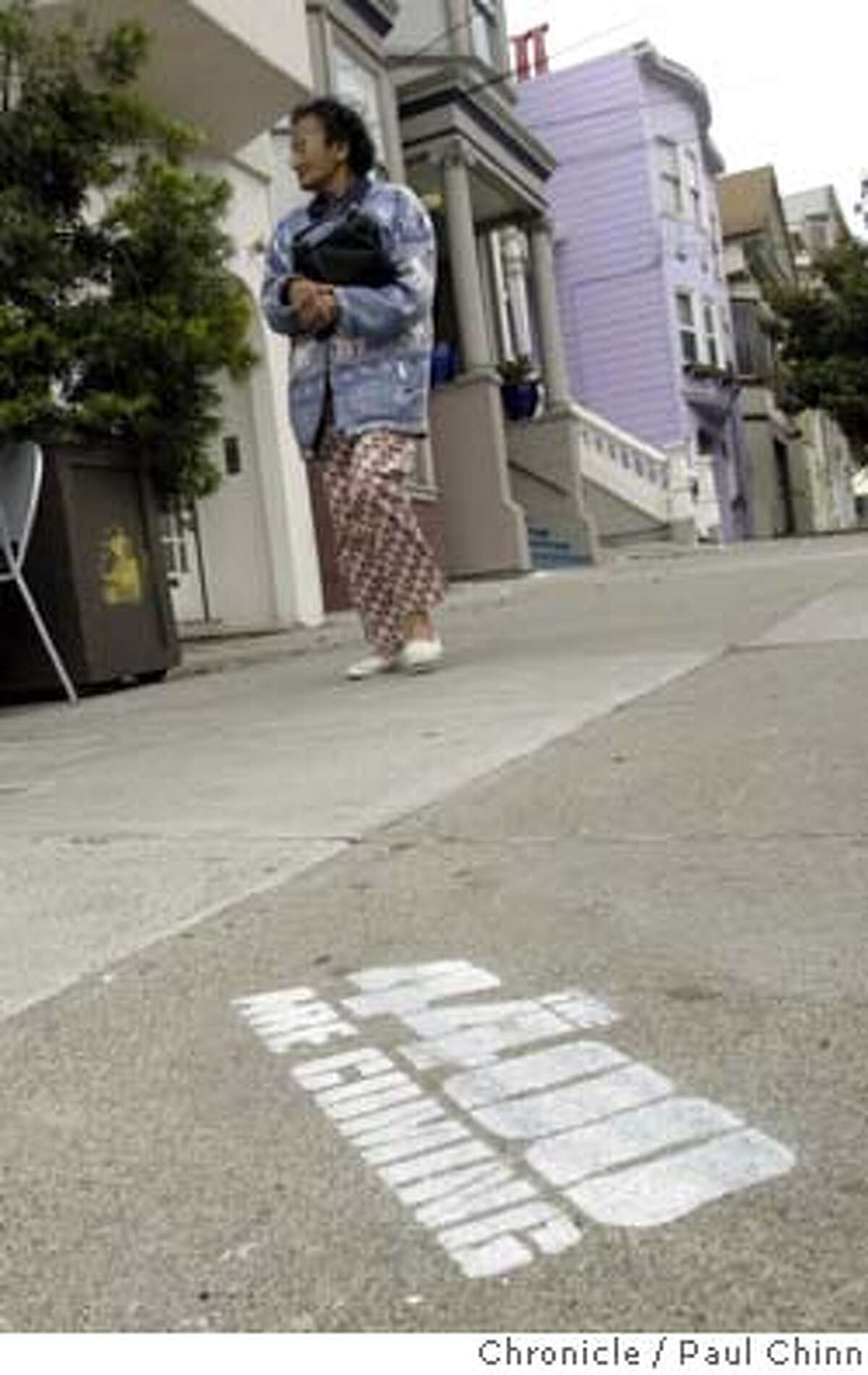 graffiti24_023_pc.jpg A pedestrian walks near an advertisement spray-painted on the sidewalk promoting a new science fiction TV series. The city is demanding the network reimburse the costs for removing the ads. Sidewalk graffiti advertising a cable TV series at 24th and Noe in San Francisco on 7/23/04. PAUL CHINN/The Chronicle MANDATORY CREDIT FOR PHOTOG AND S.F. CHRONICLE/ - MAGS OUT
